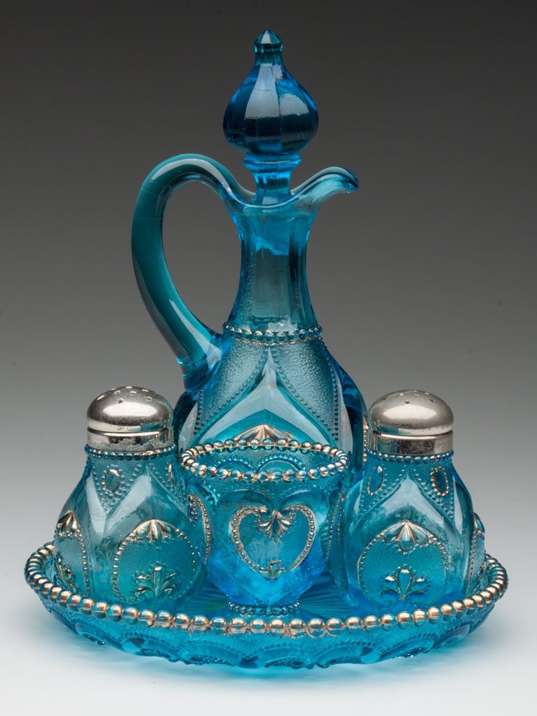 JEWELED HEART / VICTOR FIVE-PIECE CONDIMENT SET: JEWELED HEART / VICTOR FIVE-PIECE CONDIMENT SET, blue with gilt decoration, comprising a pair salt and pepper shakers with matching period lids, a cruet with correct stopper, and a toothpick holder, a