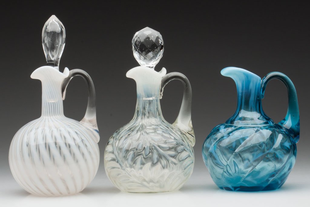 VARIOUS PATTERN OPALESCENT GLASS CRUETS, LOT OF TH: VARIOUS PATTERN OPALESCENT GLASS CRUETS, LOT OF THREE, colorless opalescent and blue opalescent, comprising a Hobbs No. 325/Swirl, Fern, and a Daisy and Fern -Parian Mold, two with an inappropriate co