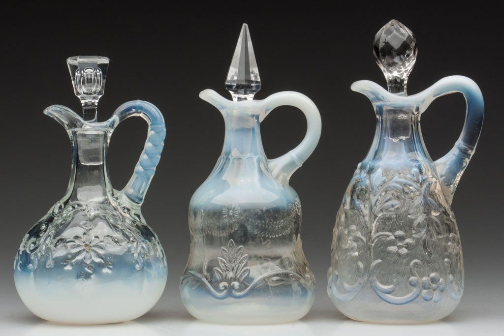VARIOUS OPALESCENT FLORAL PATTERN CRUETS, LOT OF T: VARIOUS OPALESCENT FLORAL PATTERN CRUETS, LOT OF THREE, colorless opalescent, comprising Flora, Intaglio, and Swag With Brackets, each with an inappropriate colorless stopper including two cut and a f