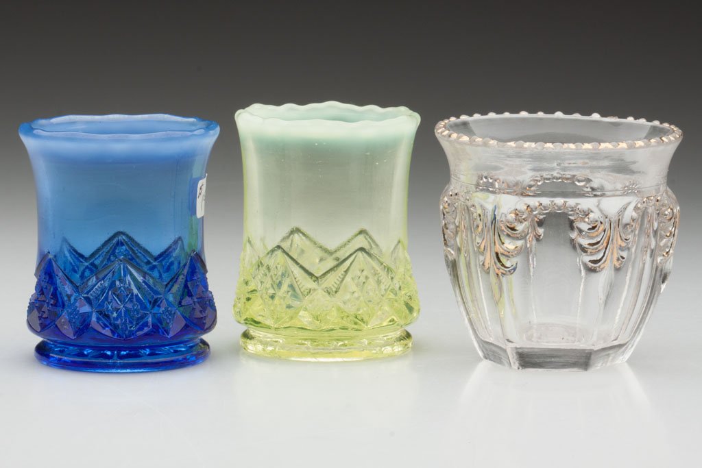 VARIOUS PATTERN TOOTHPICK HOLDERS, LOT OF THREE: VARIOUS PATTERN TOOTHPICK HOLDERS, LOT OF THREE, comprising a dark blue opalescent and a vaseline (uranium) opalescent Diamond Spearhead and a colorless with gilt decoration Fostoria No. 676 / Priscil