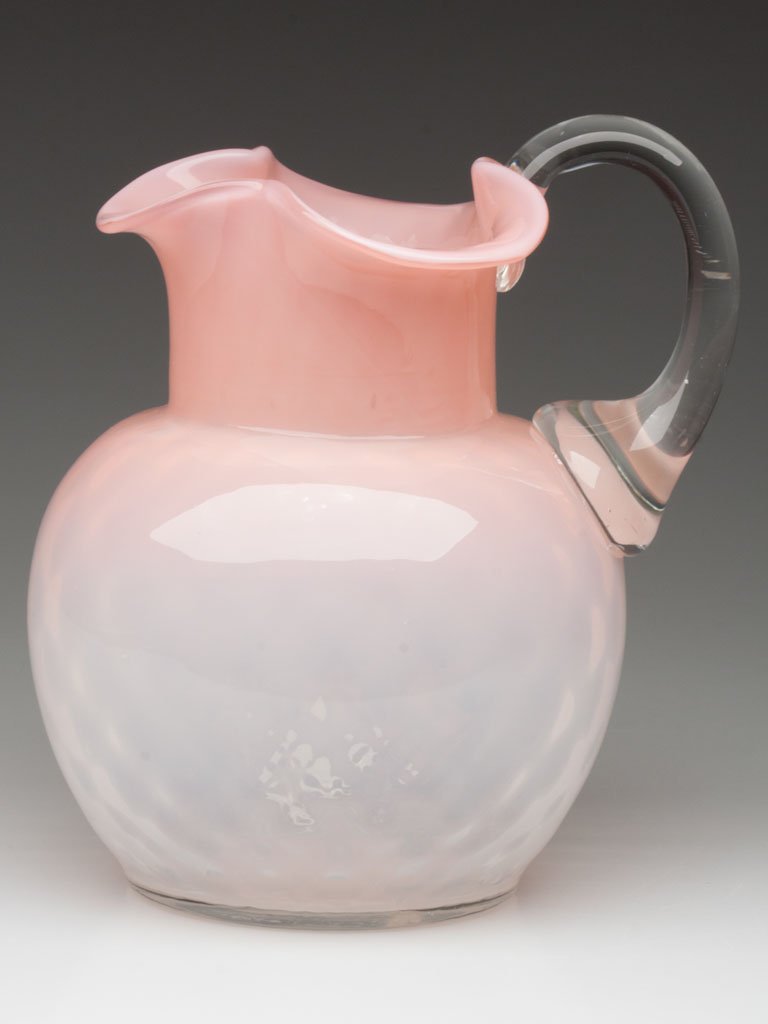 DIAMOND OPTIC OPALESCENT GLASS WATER PITCHER: DIAMOND OPTIC OPALESCENT GLASS WATER PITCHER, shaded pink opalescent, ball-form with flared triangular-form rim, colorless applied handle, polished pontil mark. Late 19th/early 20th century. 7 3/4" HO