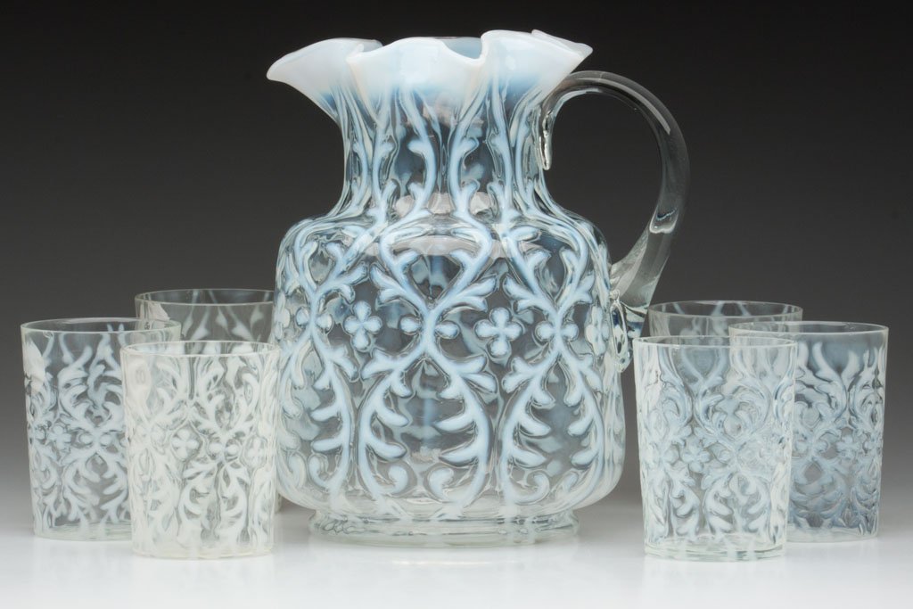 OPALINE BROCADE / SPANISH LACE - SQUAT MOLD ASSEMB: OPALINE BROCADE / SPANISH LACE - SQUAT MOLD ASSEMBLED SEVEN-PIECE WATER SET, colorless opalescent, comprising a water pitcher with star-crimped rim and colorless applied handle, and six tumblers. Late