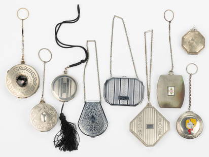 ANTIQUE / VINTAGE ART DECO CHATELAINE / CARRYING LADY'S COMPACTS, LOT OF NINE: ANTIQUE / VINTAGE ART DECO CHATELAINE / CARRYING LADY'S COMPACTS, LOT OF NINE, each with a chain, finger ring, or strap, except for an octagonal example that has a bail to attach a chain