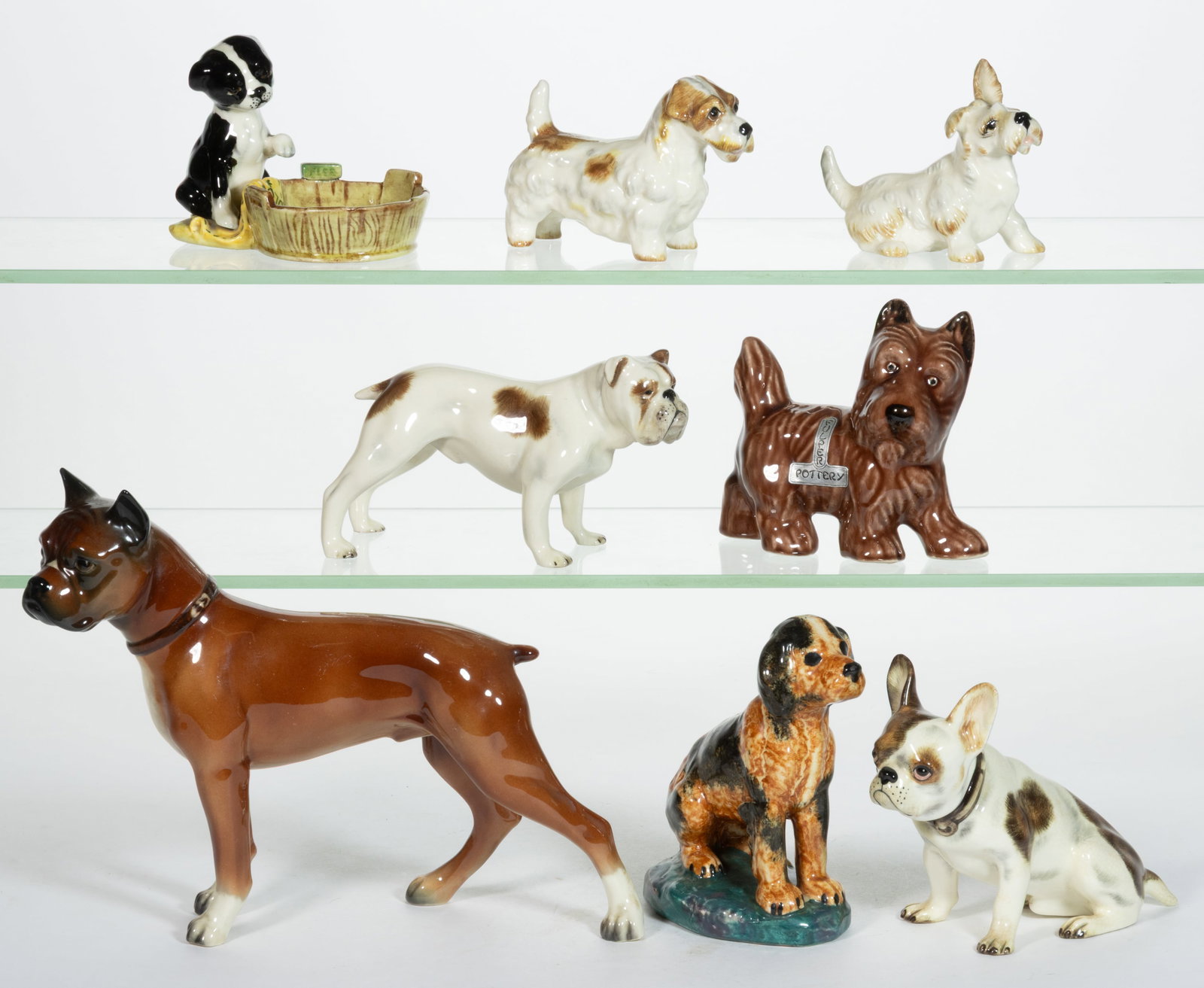 ASSORTED NEW JERSEY HAND-PAINTED CERAMIC DOG FIGURES, LOT OF EIGHT: ASSORTED NEW JERSEY HAND-PAINTED CERAMIC DOG FIGURES, LOT OF EIGHT, each having polychrome decorations, comprising one Stangl Pottery example sitting on an ovoid base, one Fulper Pottery example&