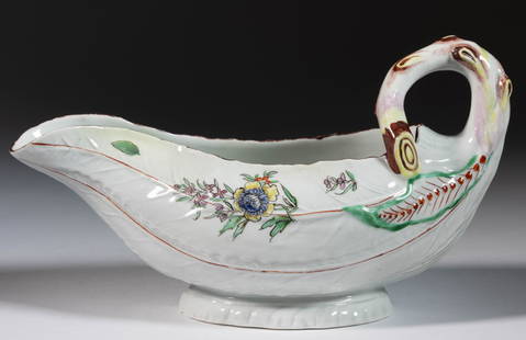 ENGLISH WORCESTER PORCELAIN LEAF-SHAPED SAUCE BOAT: ENGLISH WORCESTER PORCELAIN LEAF-SHAPED SAUCE BOAT, having polychrome hand-painted floral designs with molded lettuce leaf body and branch handle. Unmarked. Third quarter 18th century. 4 3/4"