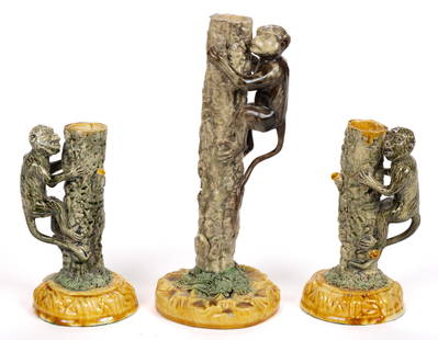 PORTUGUESE PALISSY MAJOLICA FIGURAL MONKEY CANDLESTICKS, LOT OF THREE: PORTUGUESE PALISSY MAJOLICA FIGURAL MONKEY CANDLESTICKS, LOT OF THREE, each on a circular base and depicting a monkey climbing a tree trunk with shredded clay grass at bottom. Two having impressed cro