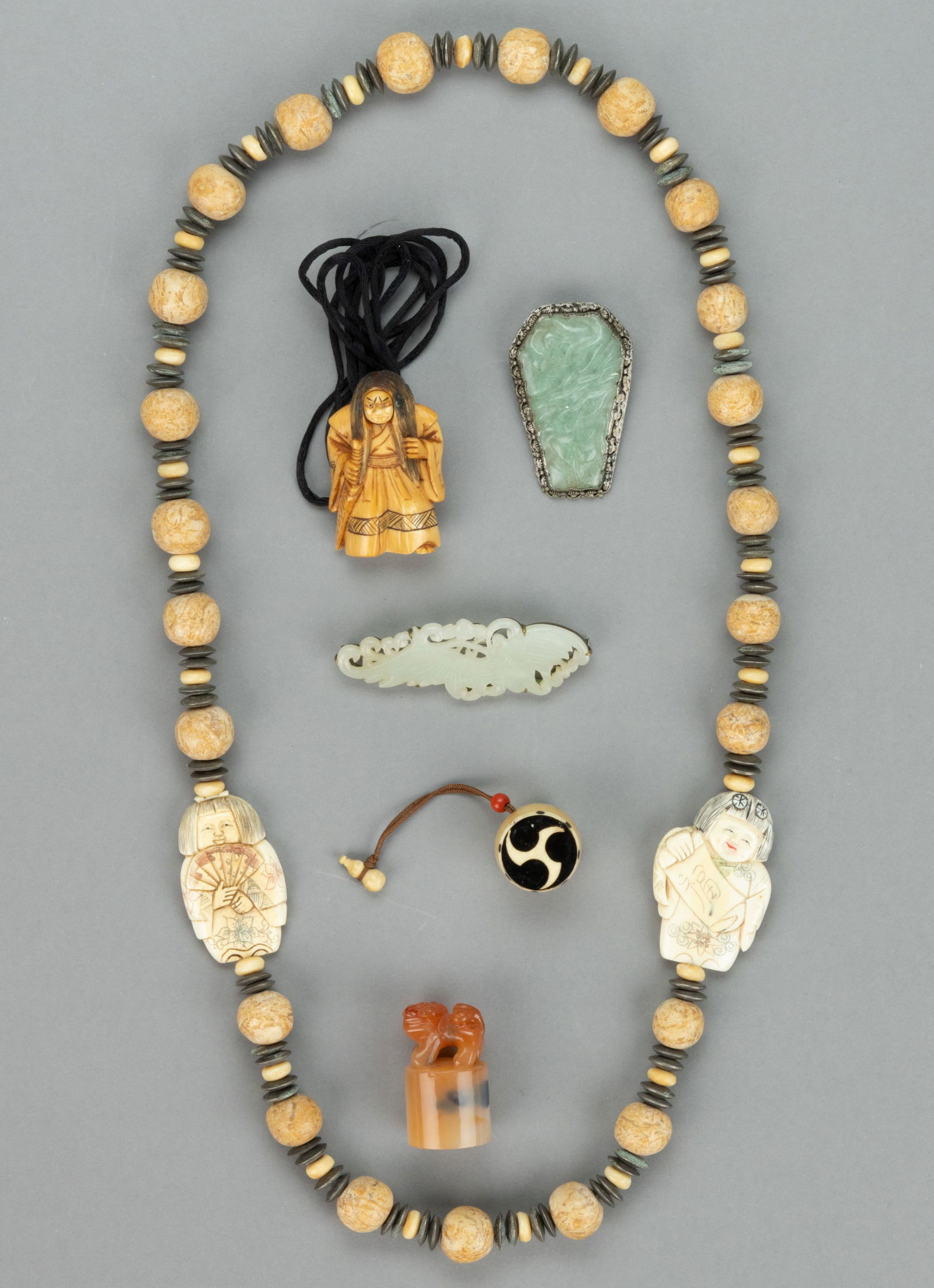 CHINESE AND JAPANESE NETSUKE, JEWELRY, AND CARVING, LOT OF SIX: CHINESE AND JAPANESE NETSUKE, JEWELRY, AND CARVING, LOT OF SIX, comprising a Japanese carved bone netsuke of a Noh actor having rotating face of a normal man face and the other of a demon, the figure