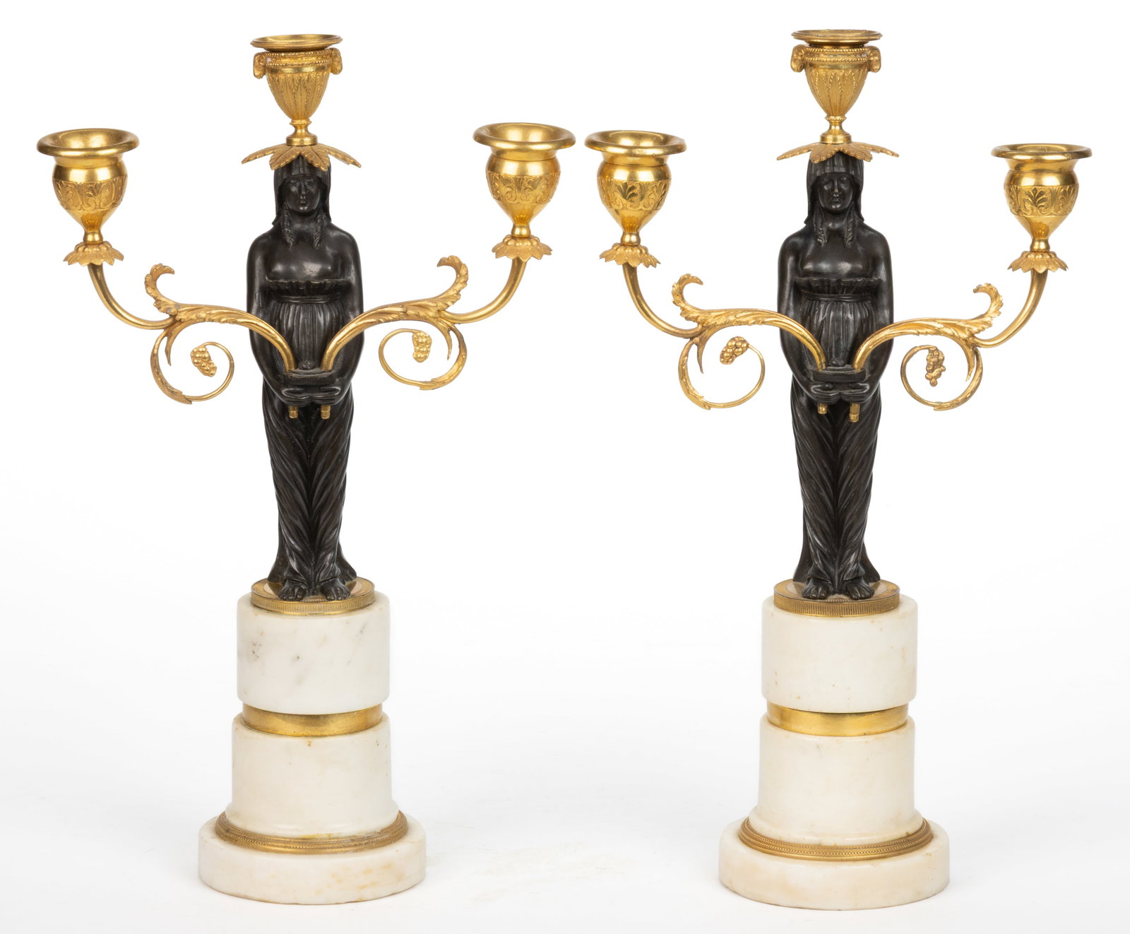 PAIR OF CLASSICAL GILT-BRASS AND PATINATED-BRONZE CANDELABRA: PAIR OF CLASSICAL GILT-BRASS AND PATINATED-BRONZE CANDELABRA, cast-bronze and brass with hand-chased detailing, each featuring a patinated bronze maiden holding two adjustable and removable arms,