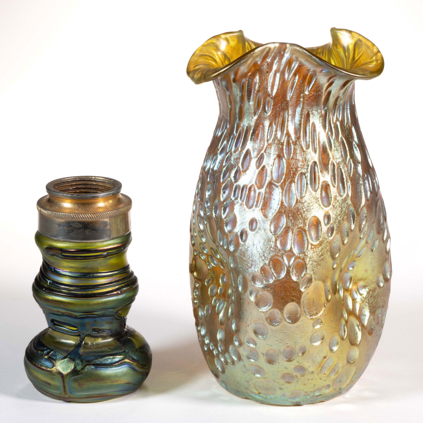 BOHEMIAN ART GLASS ARTICLES, LOT OF TWO: BOHEMIAN ART GLASS ARTICLES, LOT OF TWO, comprising a gold iridescent Loetz Diaspora pinch-side triangular vase with polished pontil mark, and a green and amethyst iridescent Pallme-Konig atomizer bas