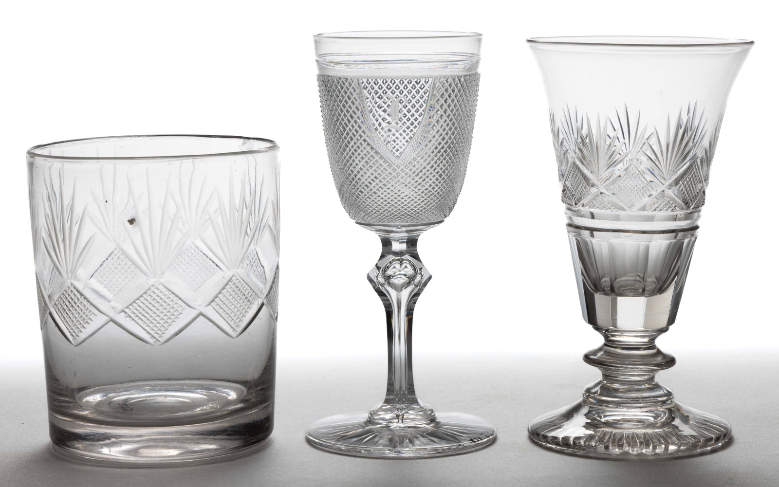 AMERICAN EARLY CUT GLASS DRINKING ARTICLES, LOT OF THREE: AMERICAN EARLY CUT GLASS DRINKING ARTICLES, LOT OF THREE, comprising a Dorflinger Tiny Diamond Point wine with shield reserve, teared facet-knop stem, and flashed star-cut foot; and a Strawberry Diamo
