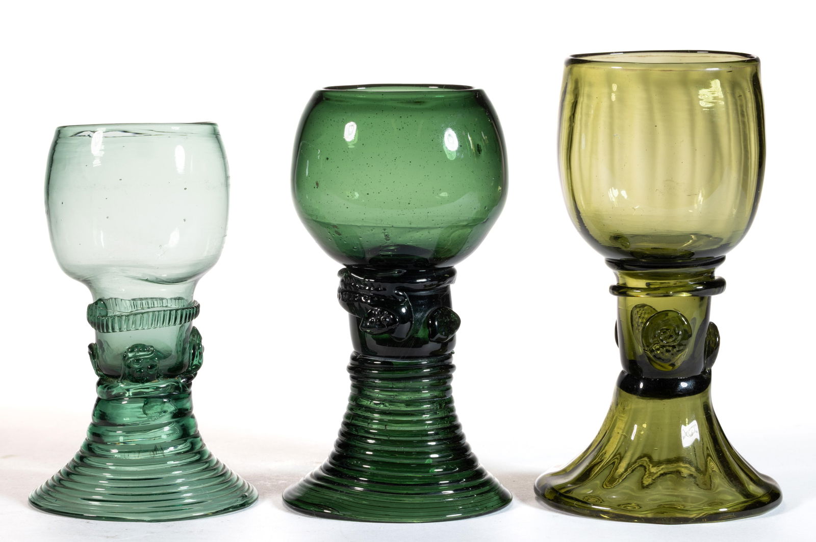 FREE-BLOWN EUROPEAN APPLIED-DECORATED GLASS ROEMER-TYPE GOBLETS, LOT OF THREE: FREE-BLOWN EUROPEAN APPLIED-DECORATED GLASS ROEMER-TYPE GOBLETS, LOT OF THREE, various shades of green, each with ovoid bowl raised on a hollow stem with applied prunts and ribbed funnel foot in
