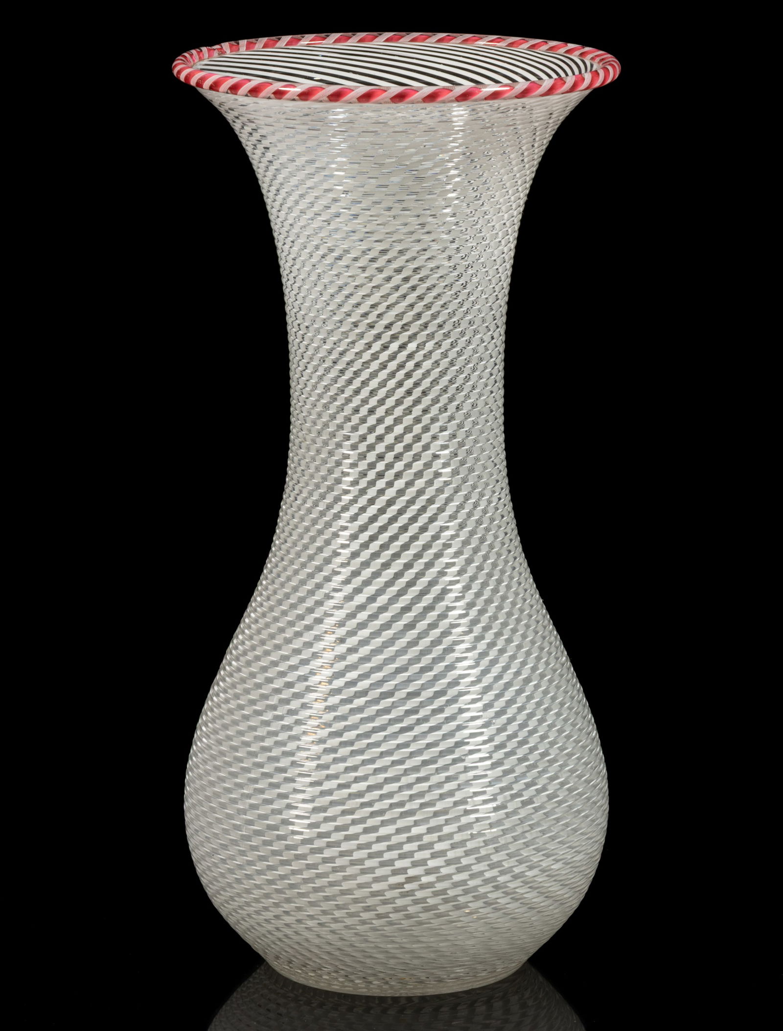 FRENCH REEDED AND SWIRLED ART GLASS VASE: FRENCH REEDED AND SWIRLED ART GLASS VASE, tall baluster form with opal swirls, applied red and opal torsade to the rim, polished pontil mark. Probably Compagnie des Cristalleries de Saint Louis.