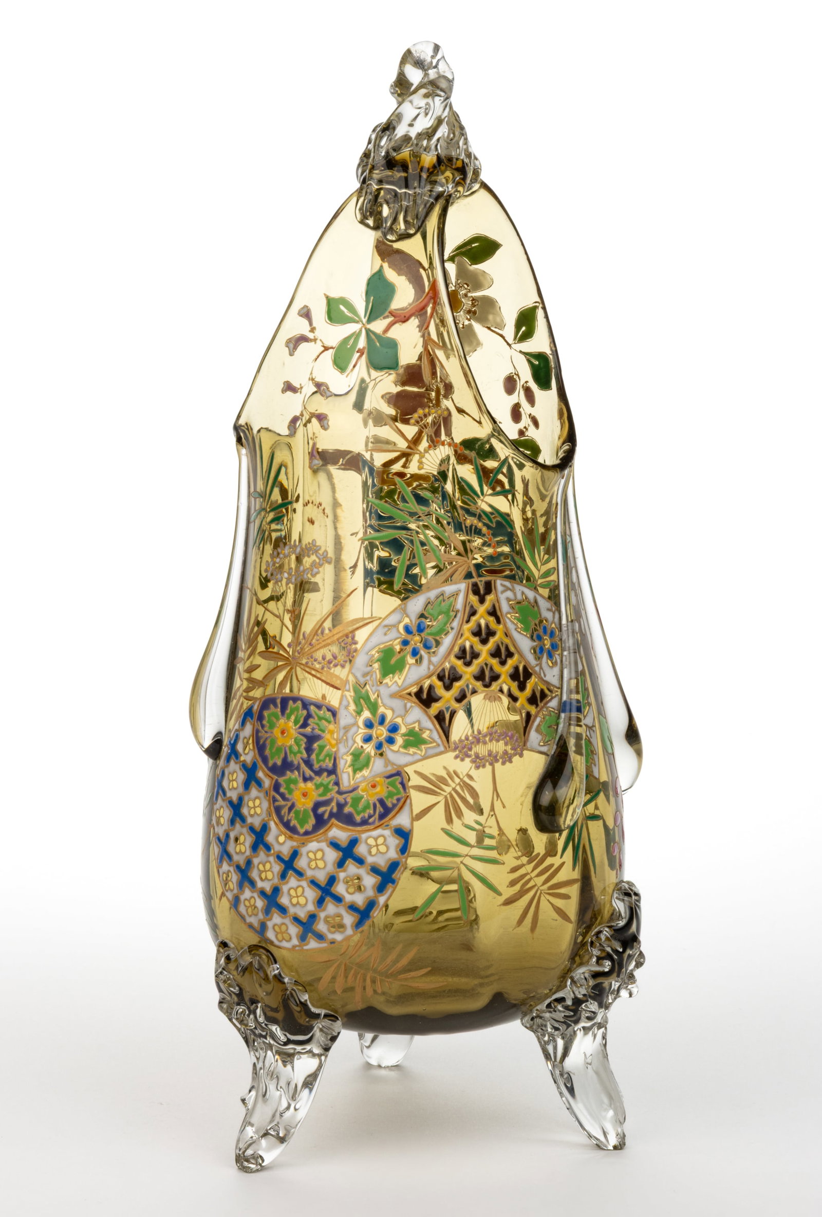 HARRACH ATTRIBUTED ENAMEL AND APPLIED DECORATED GLASS: HARRACH ATTRIBUTED ENAMEL AND APPLIED DECORATED GLASS, amber body with rim tooled up and connected with a joining colorless application to create an arch or handle, colorless applied elongated teardro