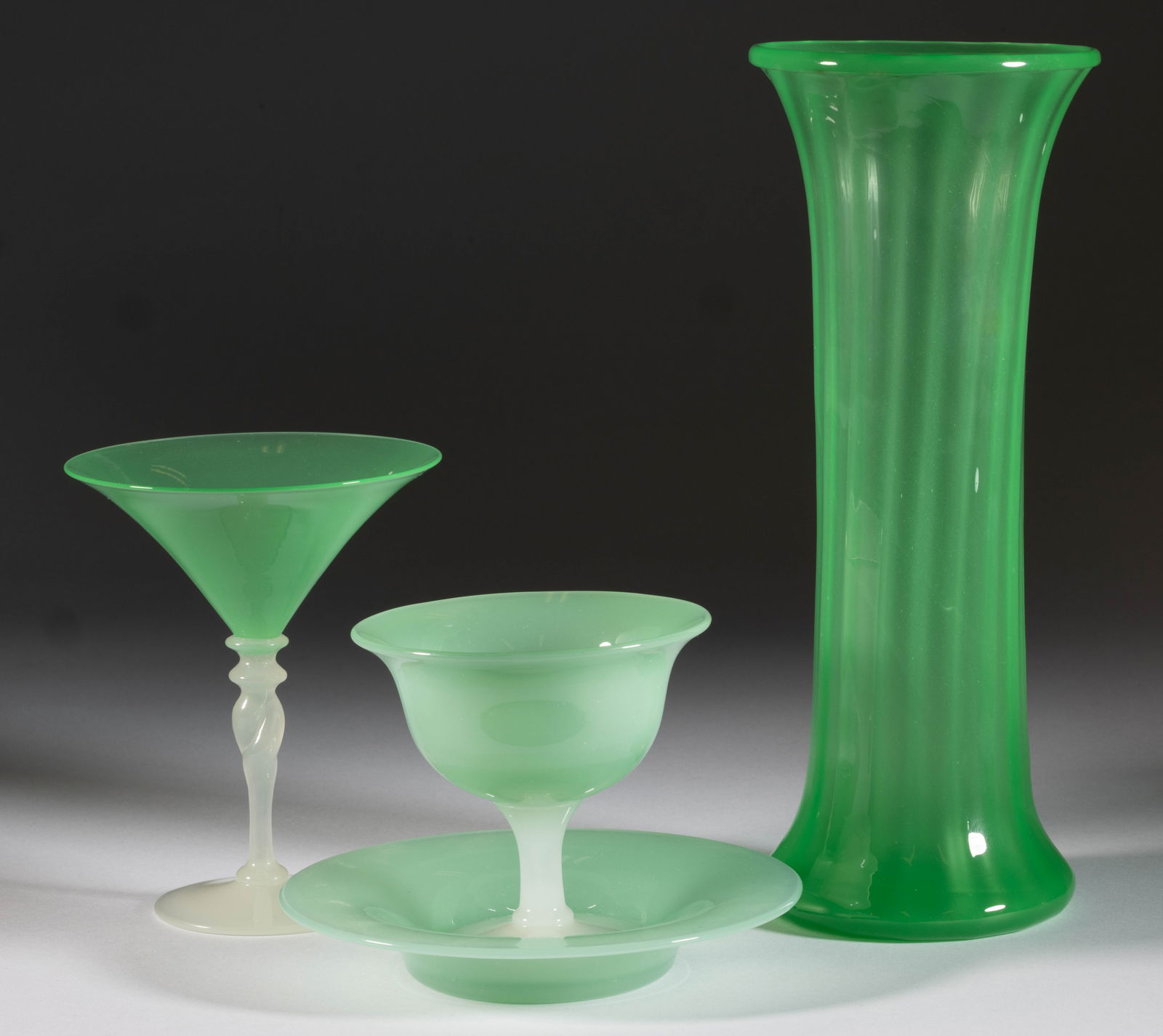 STEUBEN ATTRIBUTED JADE OPALINE ART GLASS ARTICLES, LOT OF FOUR: STEUBEN ATTRIBUTED JADE OPALINE ART GLASS ARTICLES, LOT OF FOUR, Green Jade and Alabaster, comprising a ribbed cylinder vase with acid-stamped signature to the underside, a twist-stem wine with Alabas