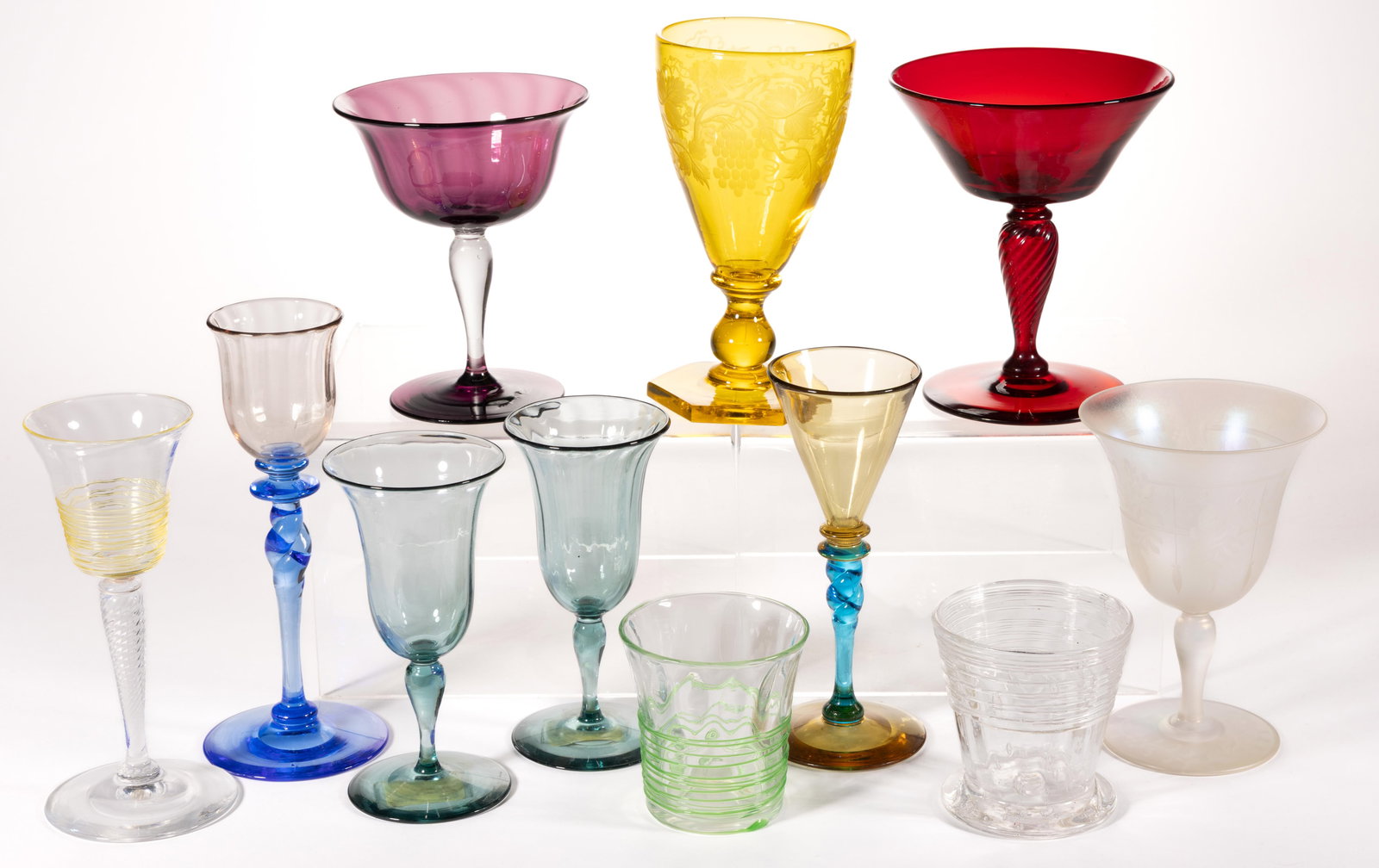 STEUBEN ART GLASS DRINKING ARTICLES, LOT OF 11: STEUBEN ART GLASS DRINKING ARTICLES, LOT OF 11, various colors, including an engraved Bristo Yellow wine, an engraved Verre de Soie wine, and a threaded/reeded wine and two juice tumblers, seven examp
