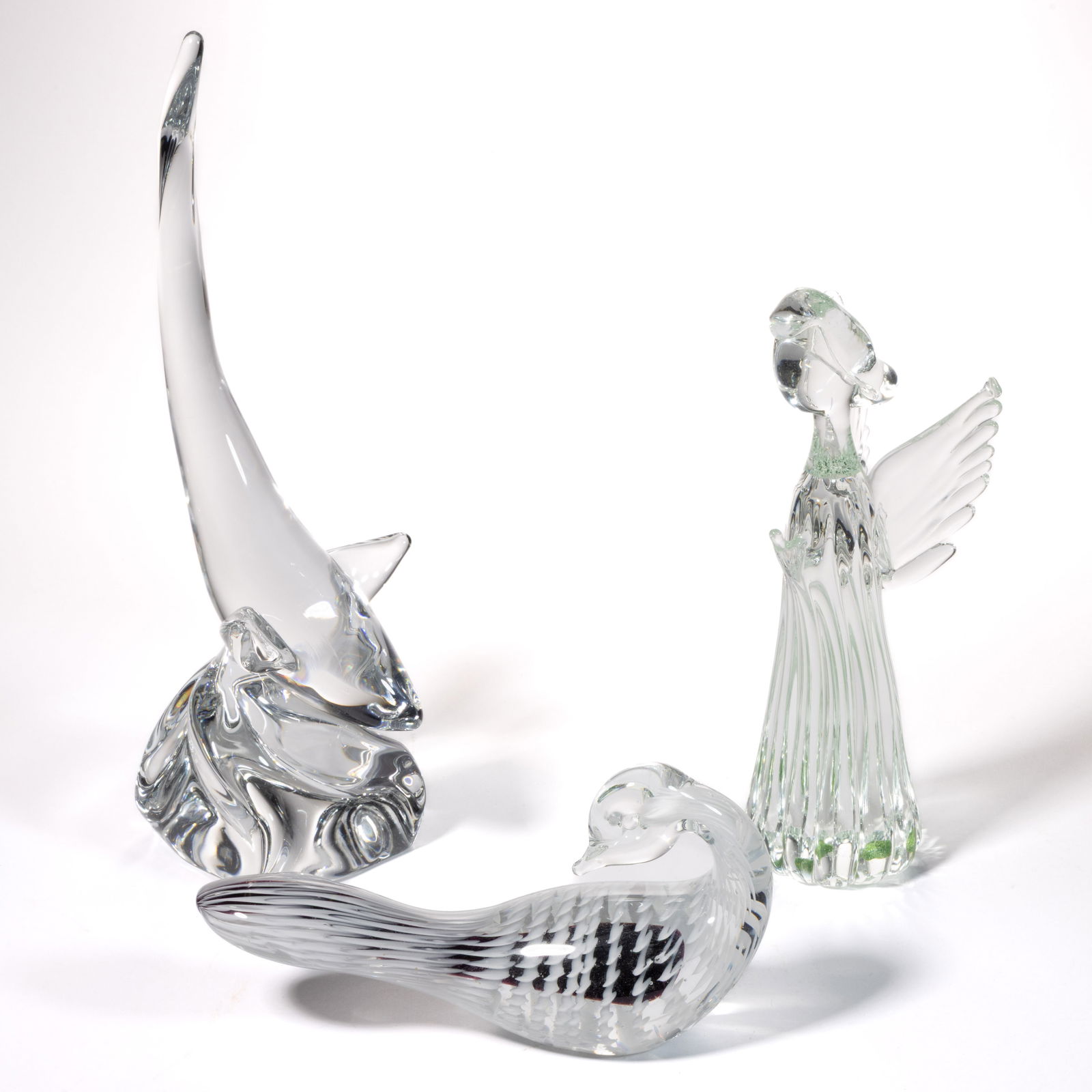 ASSORTED ART GLASS FIGURES / SCULPTURES, LOT OF THREE: ASSORTED ART GLASS FIGURES / SCULPTURES, LOT OF THREE, colorless, comprising a signed "Daum" whale with tail up, an illegibly signed colorless angel in prayer, and an unsigned duck with head