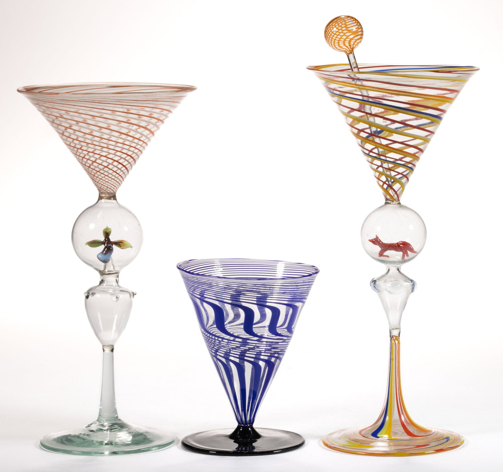 GERMAN ART GLASS BIMINI-TYPE COCKTAIL DRINKING GLASSES, LOT OF THREE: GERMAN ART GLASS BIMINI-TYPE COCKTAIL DRINKING GLASSES, LOT OF THREE, colorless with each having variously colored spiraling threaded decorations to bowls, with the larger two each having encapsu