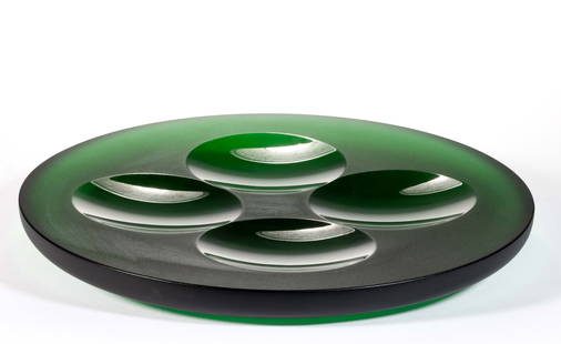FRANTISEK VIZNER (CZECH, 1936-2011) STUDIO ART GLASS PLATE: FRANTISEK VIZNER (CZECH, 1936-2011) STUDIO ART GLASS PLATE, deep emerald green, circular with four cut circles to the interior. Skrdlovice, Czechoslovakia. Circa 1975. 11 7/8" D. Provenance: