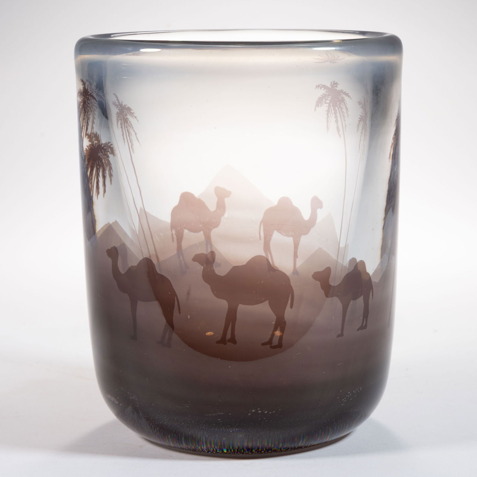 NILS LANDBERG (SWEDISH, 1901-1991) CAMELS IN THE DESERT GRAAL STUDIO ART GLASS VASE: NILS LANDBERG (SWEDISH, 1901-1991) CAMELS IN THE DESERT GRAAL STUDIO ART GLASS VASE, colorless with amethyst Graal decoration, cylindrical form with a grouping of three and two camels separated by pal