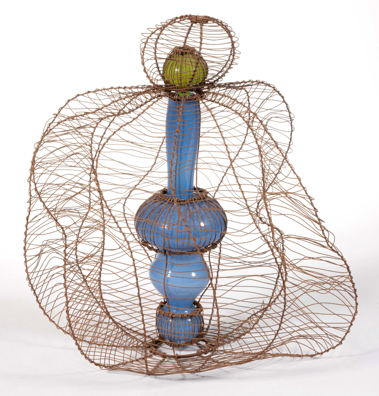 SUSAN RANKIN (CANADIAN, B. 1959) ART GLASS VESSEL AND WIRE SCULPTURE: SUSAN RANKIN (CANADIAN, B. 1959) ART GLASS VESSEL AND WIRE SCULPTURE, opaque powder blue and acid green glass, a perfume-like bottle with a stopper having a dobber the whole encased in a sinuous wire 