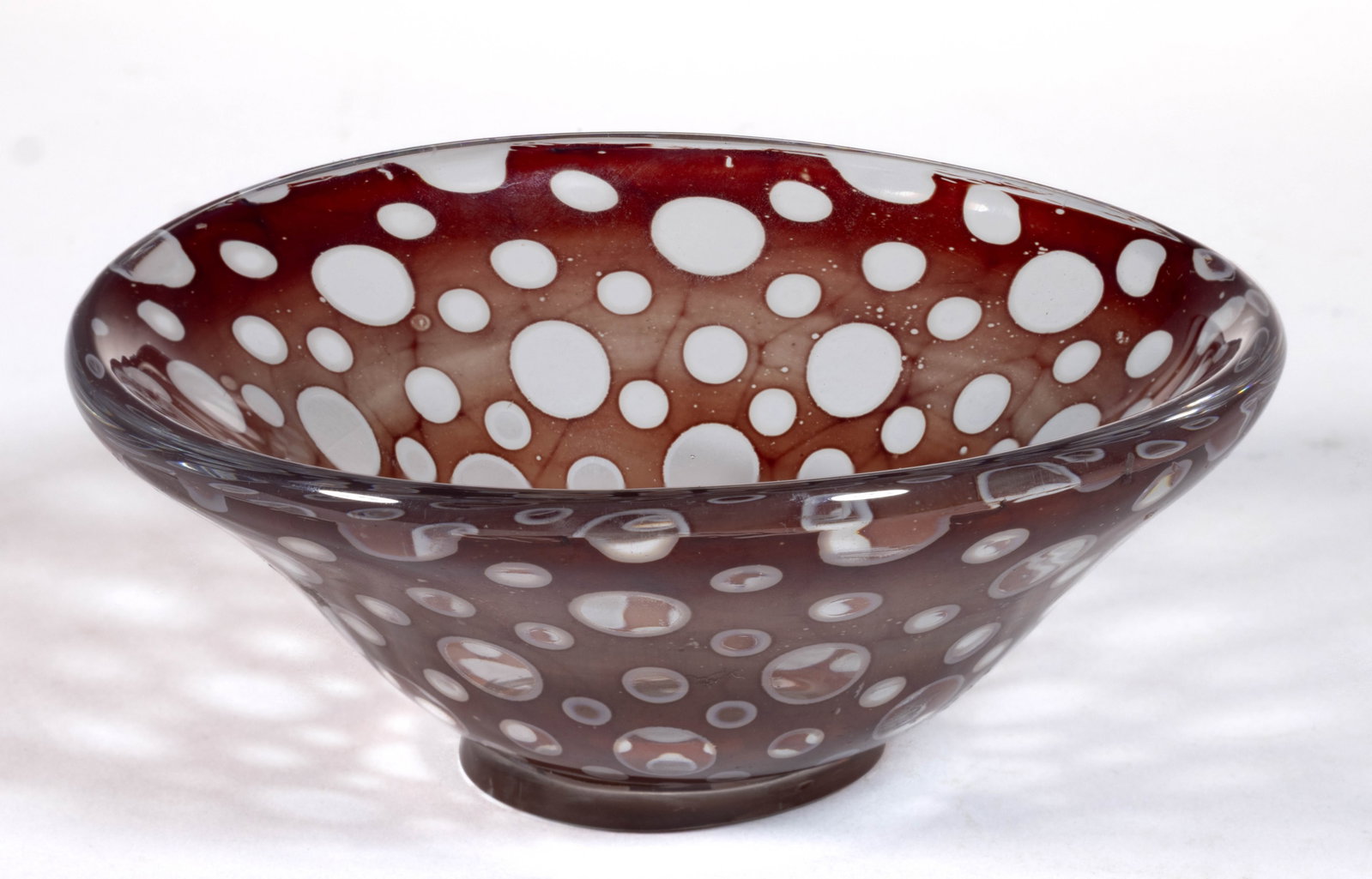 EDVARD NIELS TOVE HALD (SWEDISH, 1883-1980) CIRCLES GRAAL STUDIO ART GLASS FOOTED DISH: EDVARD NIELS TOVE HALD (SWEDISH, 1883-1980) CIRCLES GRAAL STUDIO ART GLASS FOOTED DISH, maroon, opal, and colorless, conical bowl with spaced circles with opal trim, applied colorless foot, signed to 