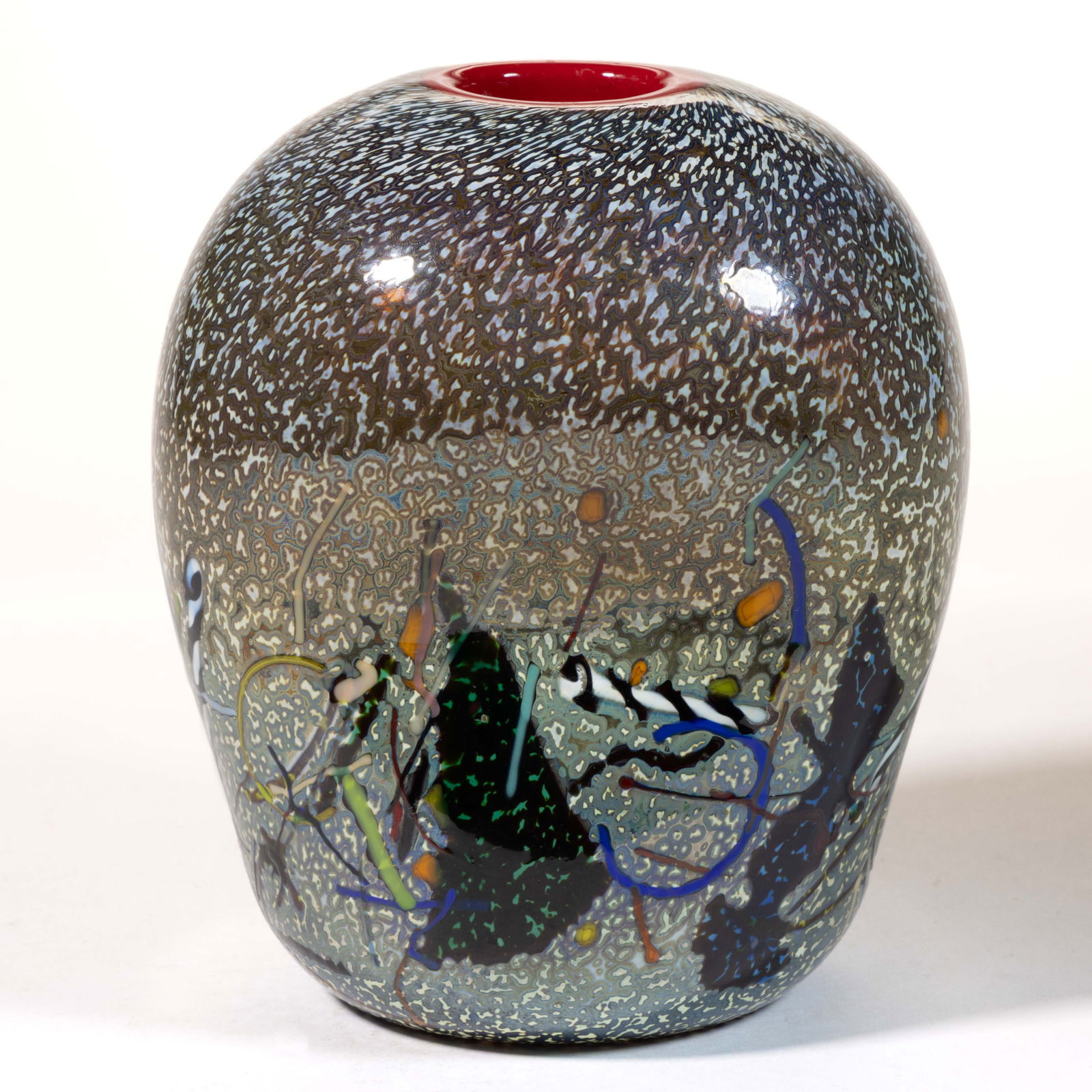 BERTIL VALLIEN (SWEDISH, B. 1938) FRIT DECORATED STUDIO ART GLASS VASE: BERTIL VALLIEN (SWEDISH, B. 1938) FRIT DECORATED STUDIO ART GLASS VASE, colorless with mottled opal and platinum decoration, waisted oval form with various applied structures in various colors, applie