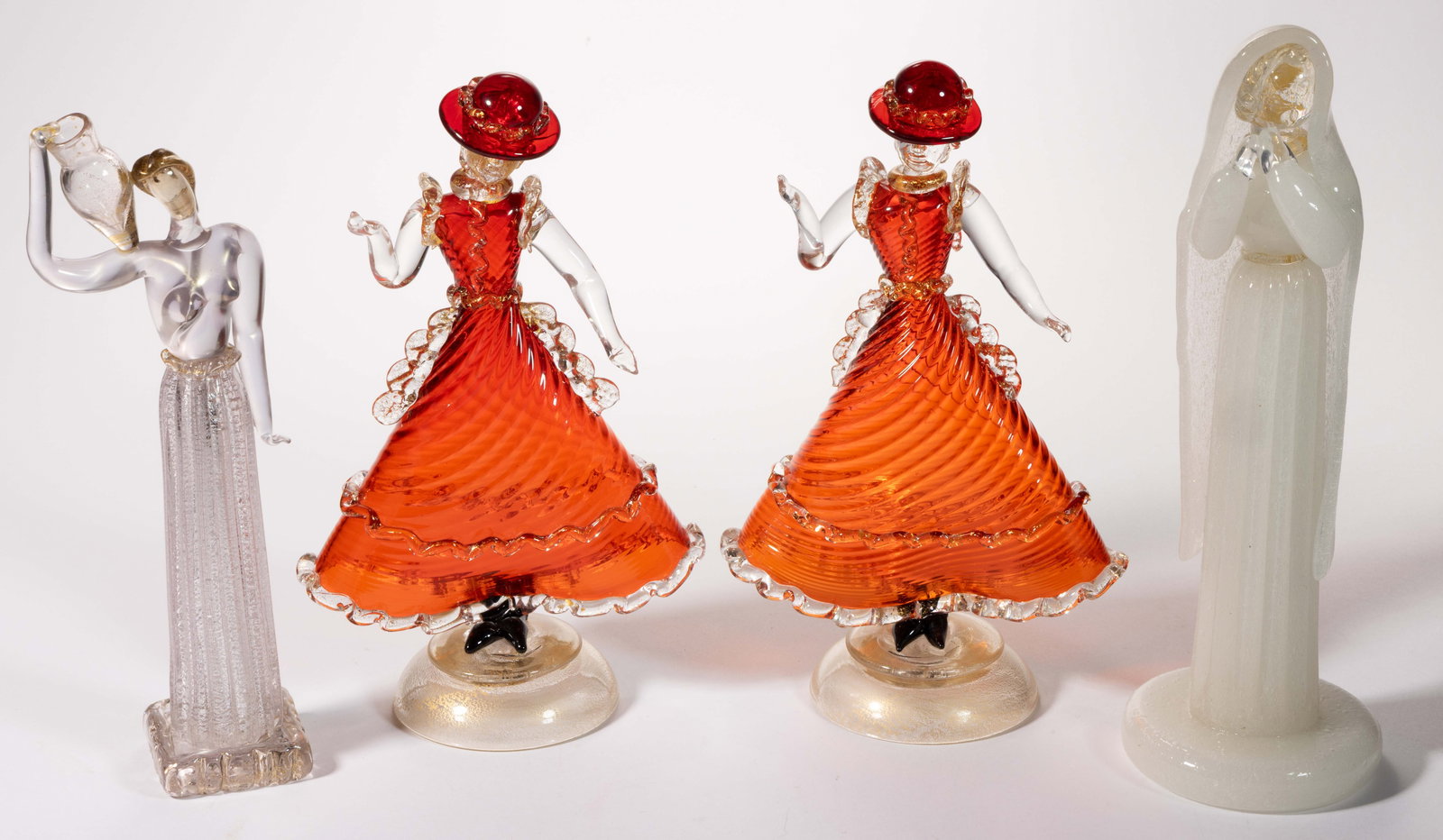 BAROVIER AND TOSSO FIGURAL ART GLASS FIGURES / SCULPTURES, LOT OF THREE: BAROVIER AND TOSSO FIGURAL ART GLASS FIGURES / SCULPTURES, LOT OF THREE, comprising a pair of dancers in ruby swirled dresses with applied rigaree and decoration with aventurine decoration, and a colo