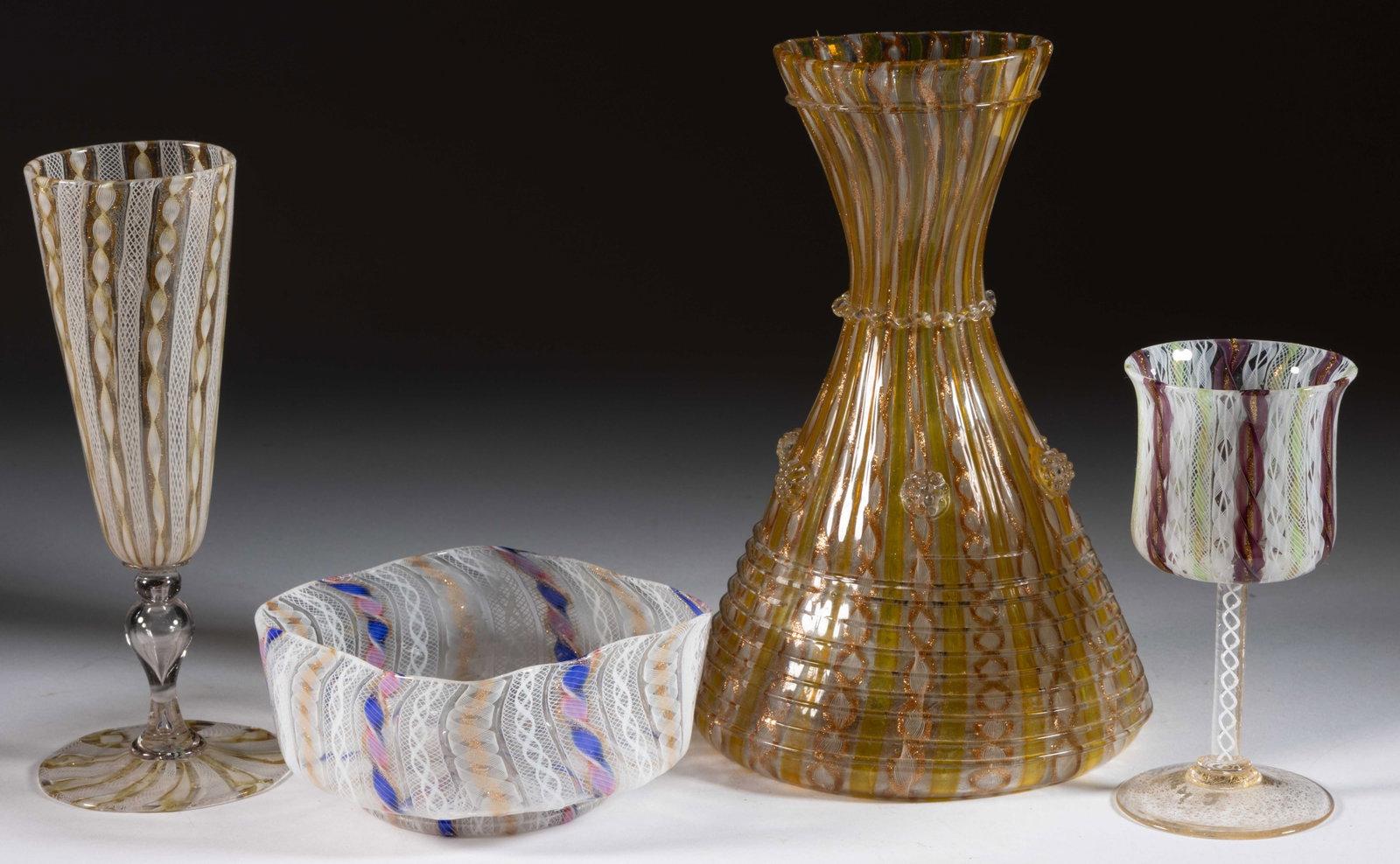 MURANO LATTICINIO / RIBBON ART GLASS ARTICLES, LOT OF FOUR: MURANO LATTICINIO / RIBBON ART GLASS ARTICLES, LOT OF FOUR, comprising a decanter with opal and aventurine filigree twists with yellow stripes in between and applied decoration to the surface, a champ