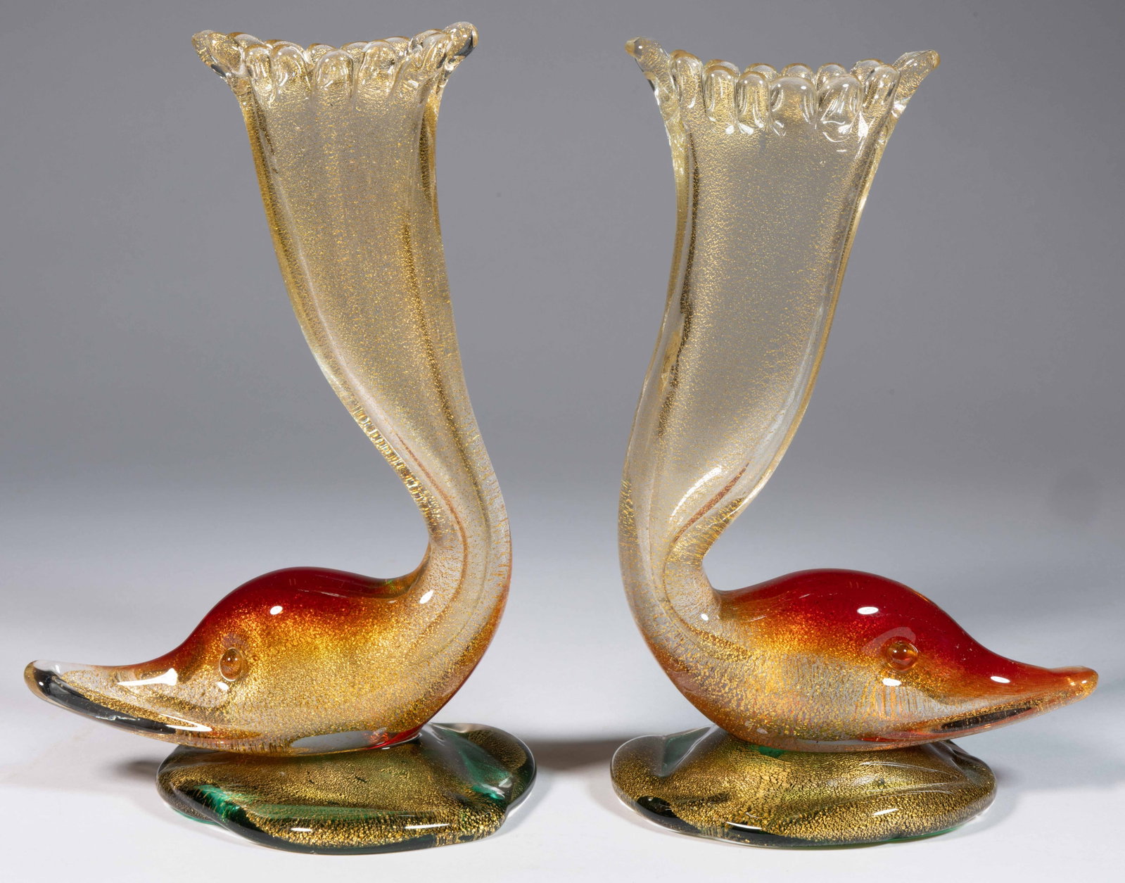 MURANO FIGURAL DUCK AND AVENTURINE DECORATED VASES: MURANO FIGURAL DUCK AND AVENTURINE DECORATED VASES, colorless vase leading to a formed head with a red top, applied green foot, each having overall aventurine decoration, polished pontil marks and bas