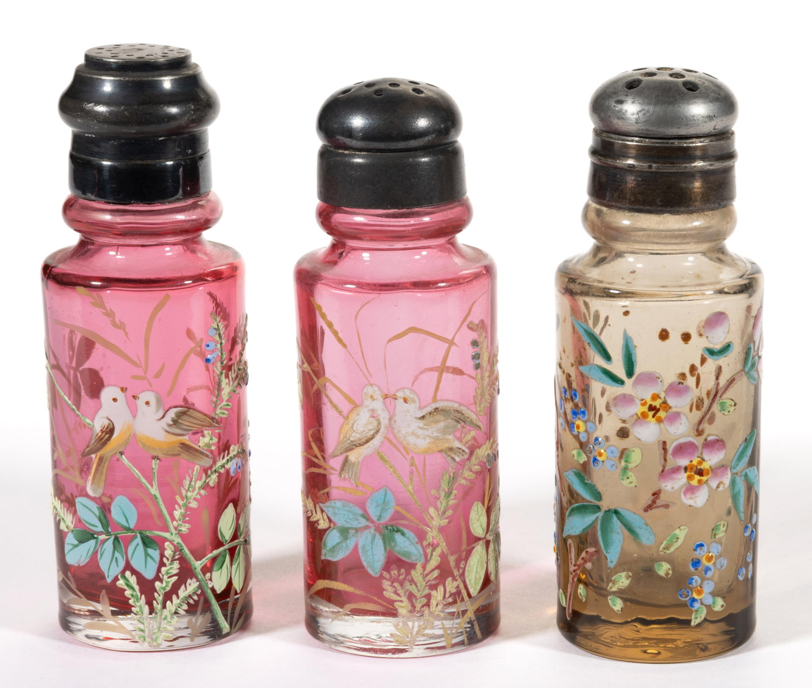 MT. WASHINGTON ENAMEL DECORATED ART GLASS SALT AND PEPPER SHAKERS, LOT OF THREE: MT. WASHINGTON ENAMEL DECORATED ART GLASS SALT AND PEPPER SHAKERS, LOT OF THREE, cased amber and cased cranberry, comprising a pair with matching lovebirds decoration with flowering vines, and a flowe