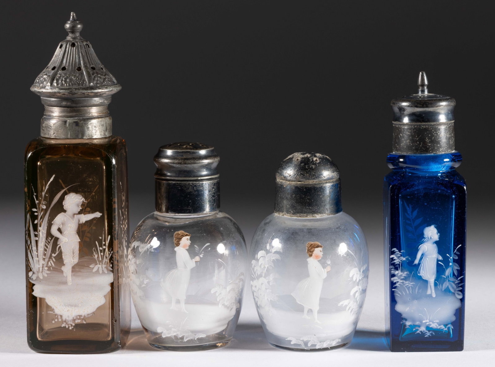 VICTORIAN MARY GREGORY (SO-CALLED) DECORATED GLASS SALT AND PEPPER SHAKERS, LOT OF FOUR: VICTORIAN MARY GREGORY (SO-CALLED) DECORATED GLASS SALT AND PEPPER SHAKERS, LOT OF FOUR, comprising two colorless bulbous forms with decoration having a colored face and hair, and a blue and apri