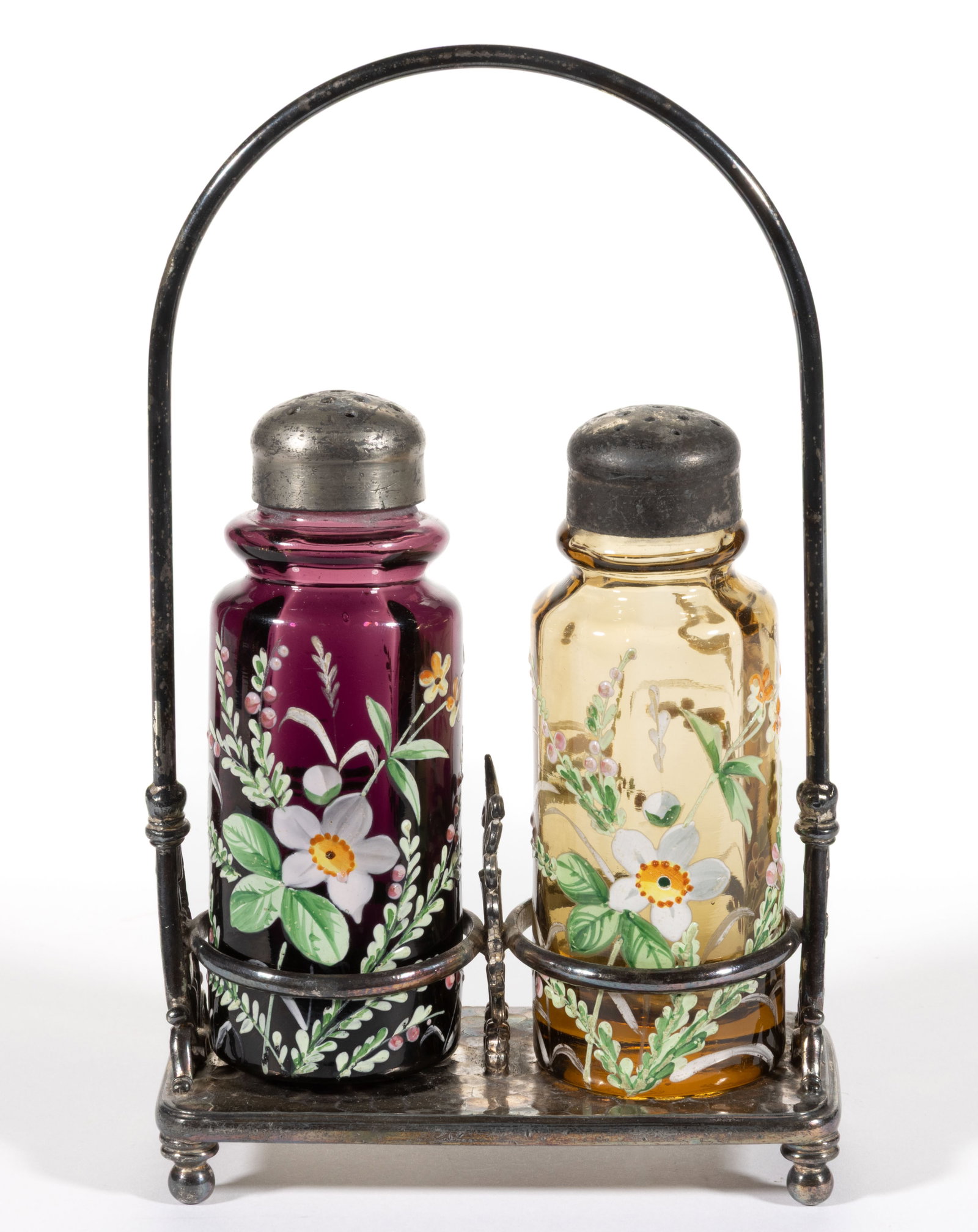 VICTORIAN PANEL-OPTIC ENAMEL-DECORATED GLASS SALT AND PEPPER SHAKER IN STAND: VICTORIAN PANEL-OPTIC ENAMEL-DECORATED GLASS SALT AND PEPPER SHAKER IN STAND, comprising an amber and an amethyst example with matching floral decoration, each having a period lid; fitted into a quadr