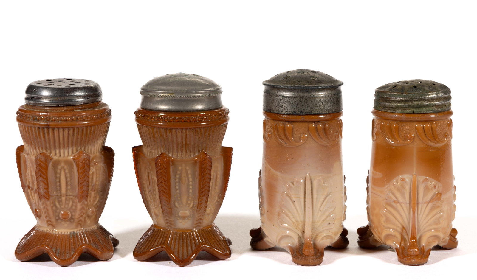 GREENTOWN CHOCOLATE PRESSED GLASS SALT AND PEPPER SHAKERS, LOT OF FOUR: GREENTOWN CHOCOLATE PRESSED GLASS SALT AND PEPPER SHAKERS, LOT OF FOUR, chocolate, comprising two Leaf Bracket and two Cactus, each having a period lid. Indiana Tumbler & Goblet Co. Circa 190