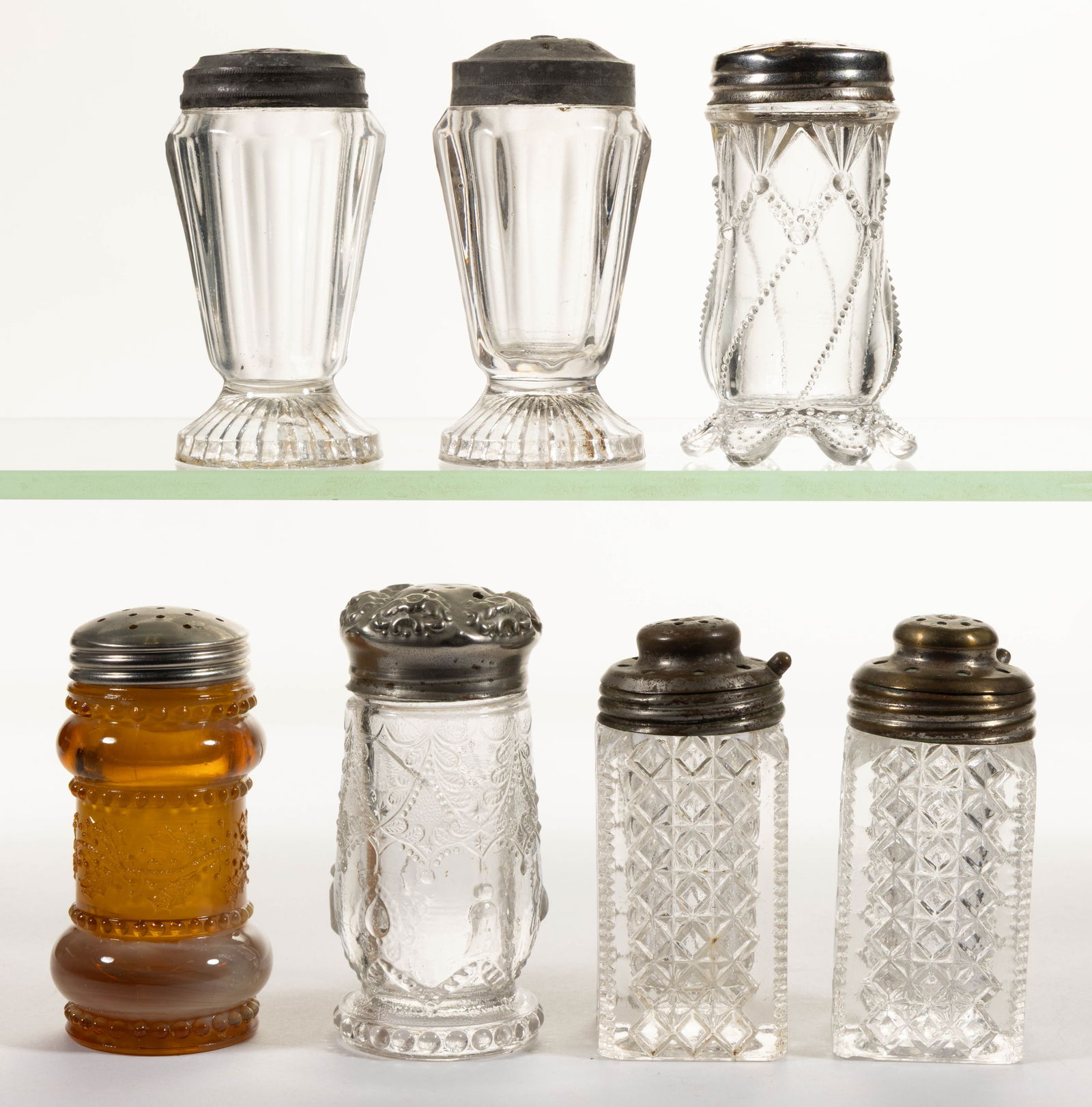GREENTOWN PRESSED GLASS SALT AND PEPPER SHAKERS, LOT OF SEVEN: GREENTOWN PRESSED GLASS SALT AND PEPPER SHAKERS, LOT OF SEVEN, mostly colorless but also including one Holly Amber (Golden Agate), otherwise comprising one No. 102 / Teardrop & Tassel, one No. 350