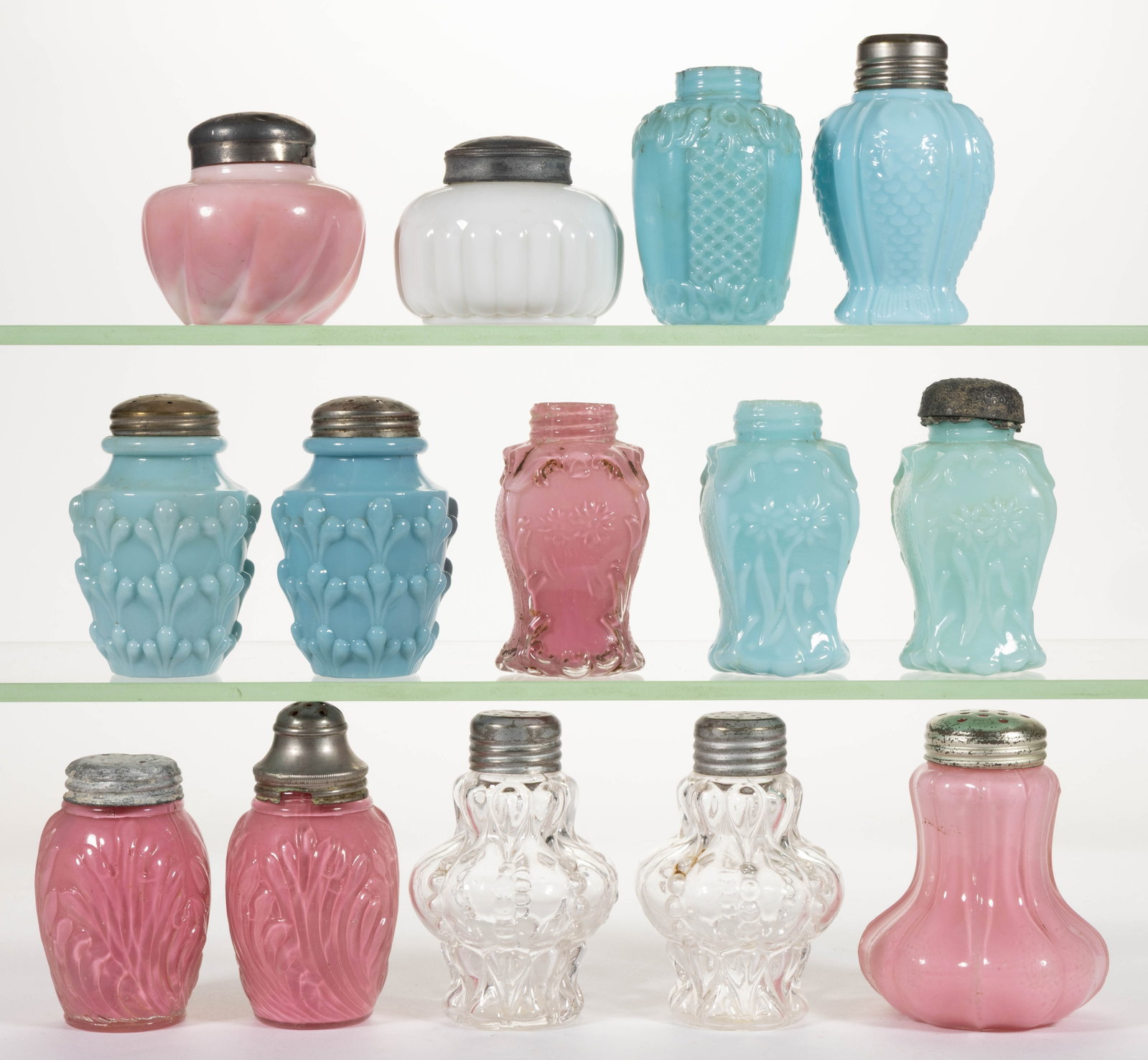 ASSORTED CONSOLIDATED OPAQUE GLASS SALT AND PEPPER SHAKERS, LOT OF 14: ASSORTED CONSOLIDATED OPAQUE GLASS SALT AND PEPPER SHAKERS, LOT OF 14, cased pink, opaque blue, colorless, and white/pink mottled examples, including Argus Swirl, Fish, Half Ribbed, Alt
