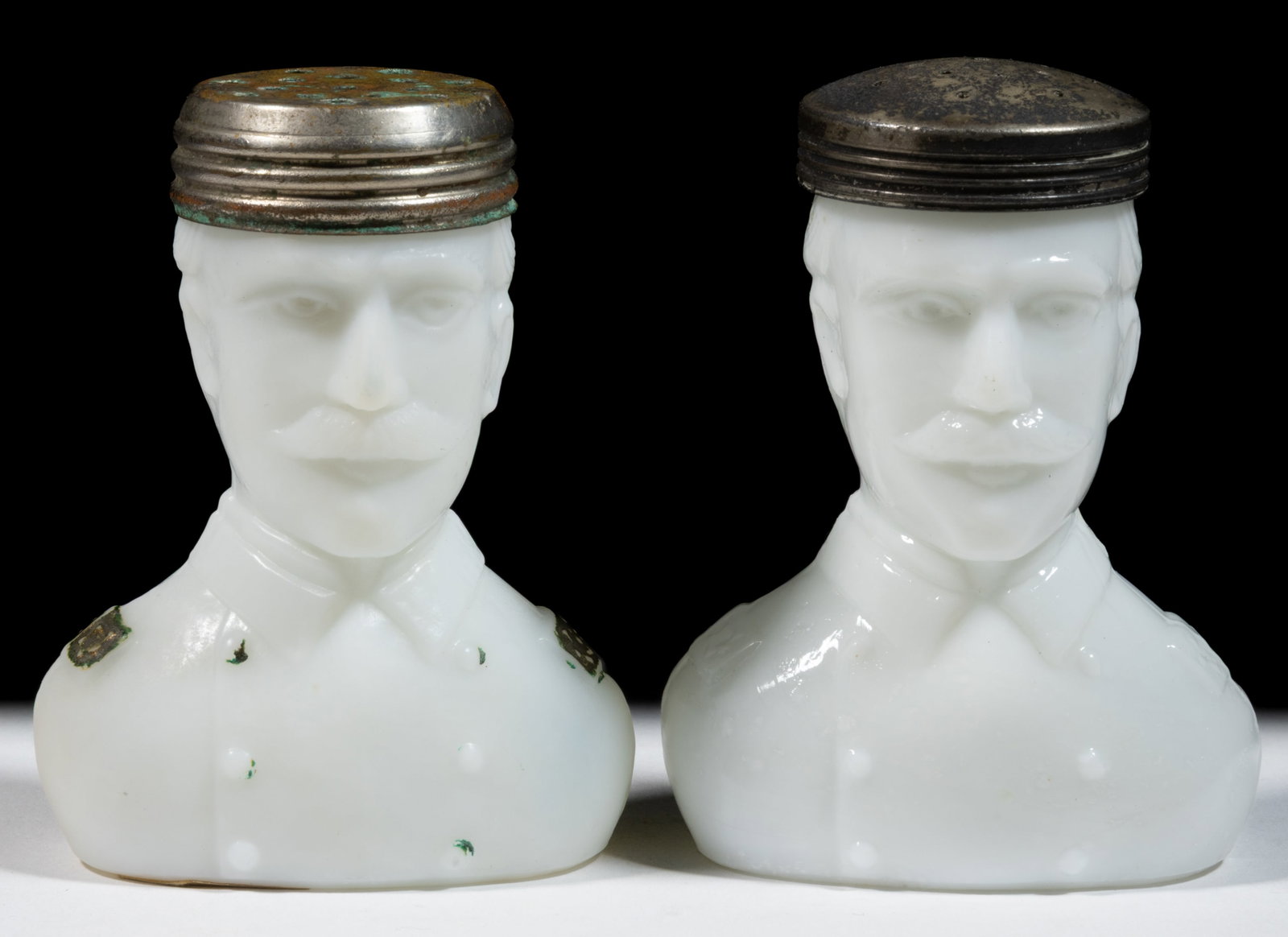 SPANISH-AMERICAN WAR COMMEMORATIVE "ADMIRAL DEWEY" FIGURAL MILK GLASS SALT SHAKERS, LOT OF TWO: SPANISH-AMERICAN WAR COMMEMORATIVE "ADMIRAL DEWEY" FIGURAL MILK GLASS SALT SHAKERS, LOT OF TWO, opaque white/milk glass, one glossy and one with satin finish, in the form of a shoulder-