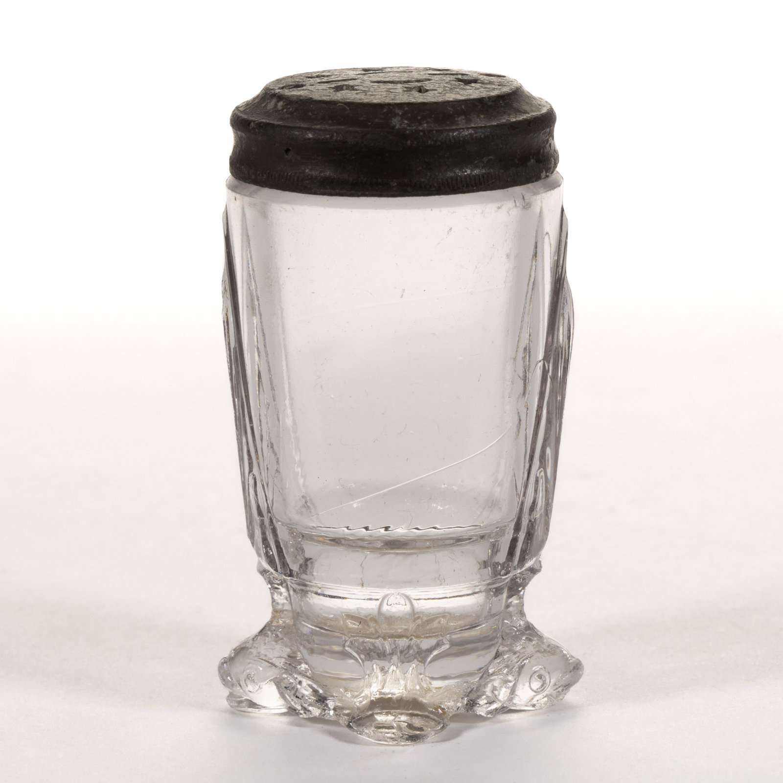 DOLPHIN EAPG SALT SHAKER: DOLPHIN EAPG SALT SHAKER, colorless, supported on four feet, two of which are dolphins, period lid. Hobbs, Brockunier & Co. Pattern introduced in the 1880s. 2 3/4" HOA, 1 5/8" DOA base.&