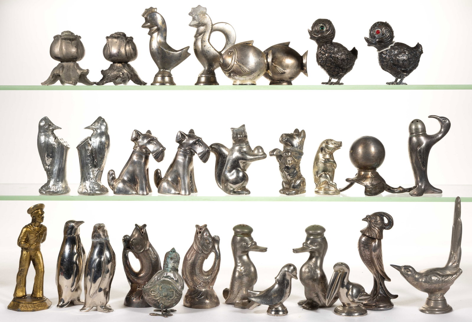 ASSORTED SILVER-PLATED AND OTHER METAL FIGURAL SALT AND PEPPER SHAKERS, LOT OF 29: ASSORTED SILVER-PLATED AND OTHER METAL FIGURAL SALT AND PEPPER SHAKERS, LOT OF 29, including a pair of Scottish Terrier dogs by Weidlich Bros. Mfg. Co. of Bridgeport, CT (active 1902-c.1950), a f
