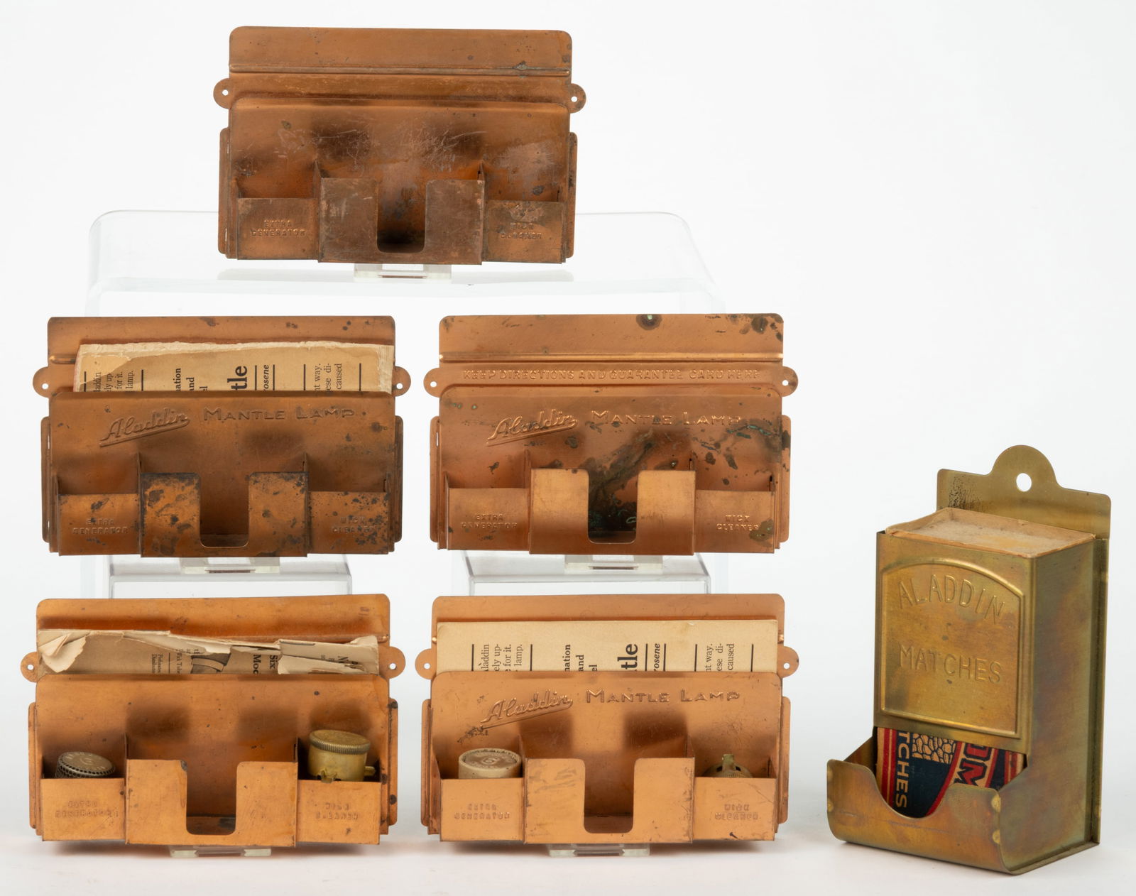 ASSORTED ALADDIN WALL-MOUNT MATCH AND ACCESSORY HOLDERS, LOT OF SIX: ASSORTED ALADDIN WALL-MOUNT MATCH AND ACCESSORY HOLDERS, LOT OF SIX, comprising five copper examples for holding wick cleaner, generator/flame spreader, and matches, three examples fitted with a paper