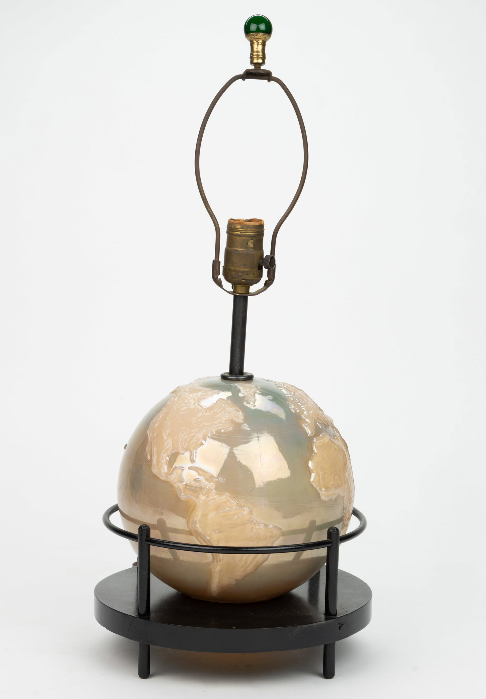 ALADDIN MODEL NO. G-348 / WORLD GLOBE ELECTRIC TABLE LAMP: ALADDIN MODEL NO. G-348 / WORLD GLOBE ELECTRIC TABLE LAMP, alacite with green-blue iridescent-type highlights to the unpatterned body, raised embossing of world continents, fitted on a black pain