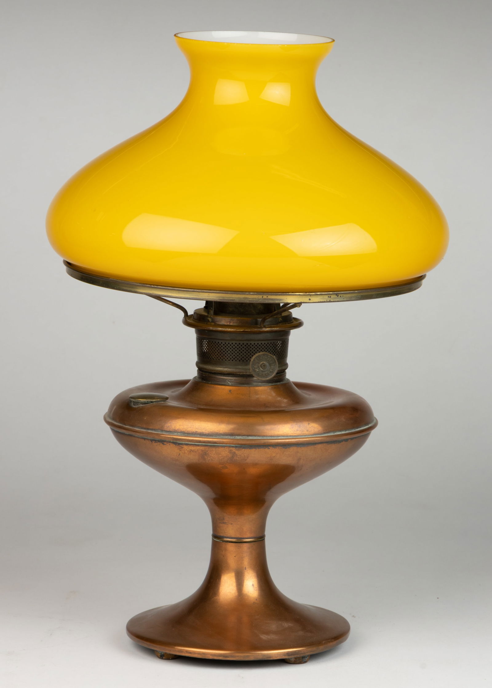 ALADDIN-STYLE COPPER FINISH BRASS KEROSENE TABLE STAND LAMP: ALADDIN-STYLE COPPER FINISH BRASS KEROSENE TABLE STAND LAMP, compressed globular-form font with slight concave top, circular-form foot with iron table ring and four ball-form feet, underside impressed