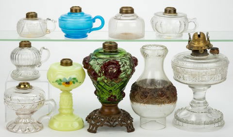 ASSORTED PATTERNED KEROSENE STAND AND FINGER LAMPS, LOT OF NINE