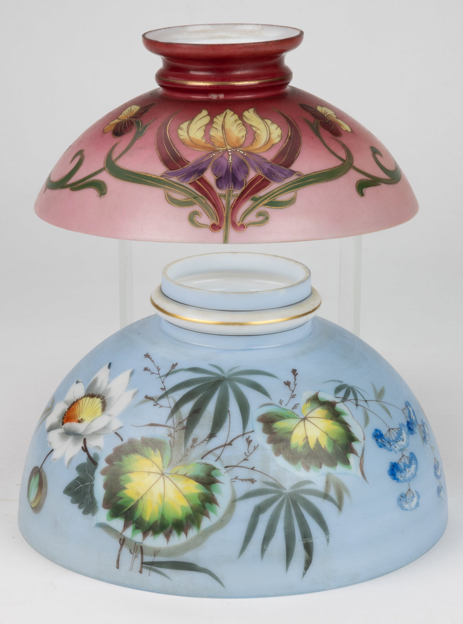 VICTORIAN DECORATED OPAL KEROSENE LAMP SHADES, LOT OF TWO: VICTORIAN DECORATED OPAL KEROSENE LAMP SHADES, LOT OF TWO, opal with pale blue ground and overall floral decoration, umbrella form with ringed neck, 6" H, 10" D fitter; and a dark to li