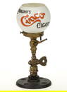 CAST-BRASS AND IRON COUNTER-TOP GAS CIGAR LIGHTER WITH EISENLOHR'S CINCO CIGARS GLASS SHADE