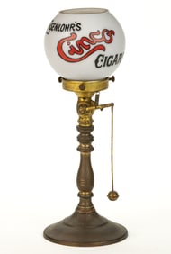 CAST-BRASS AND IRON COUNTER-TOP GAS CIGAR LIGHTER WITH EISENLOHR'S CINCO CIGARS GLASS SHADE