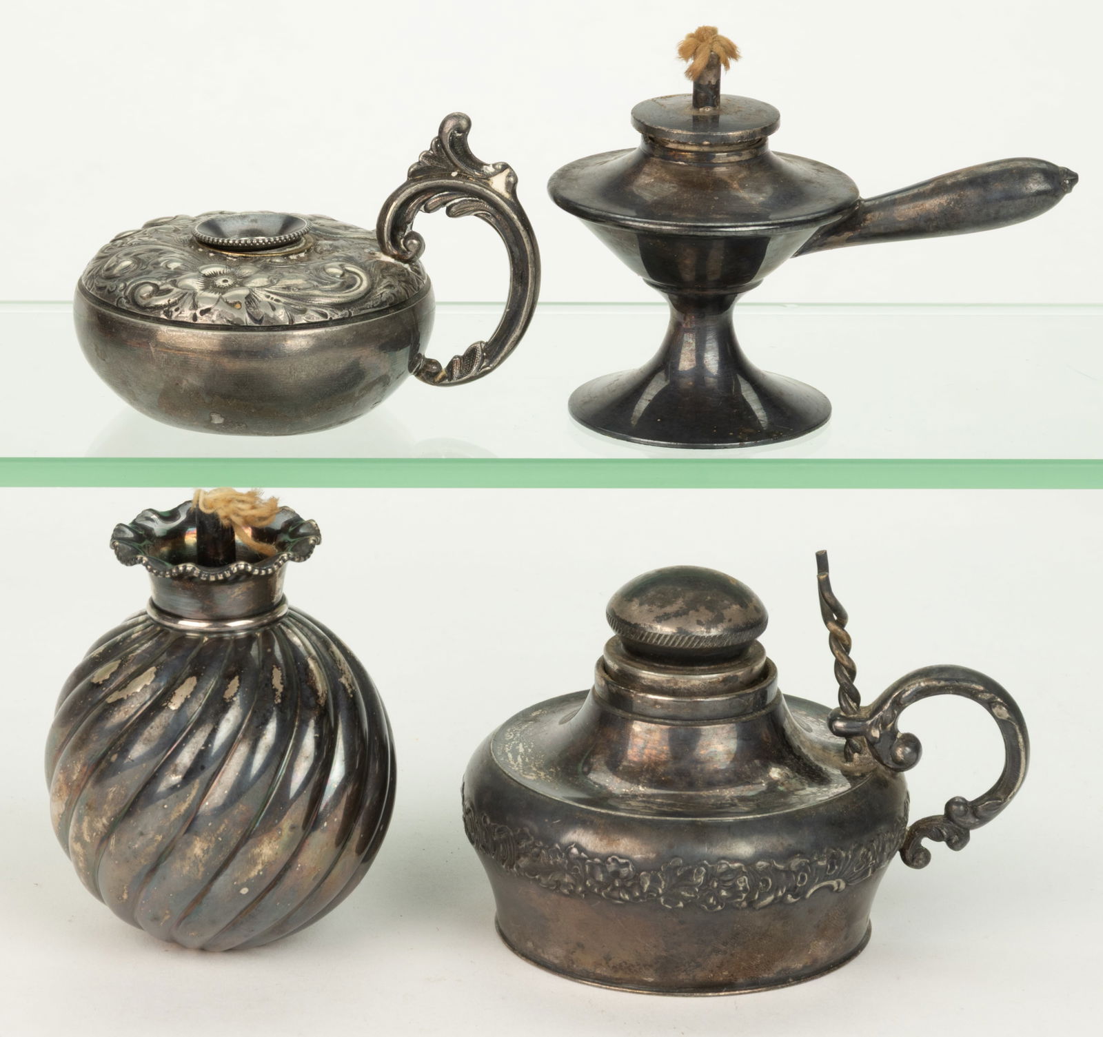 ASSORTED SILVER-PLATED TABLE-TOP CIGAR LIGHTERS, LOT OF FOUR: ASSORTED SILVER-PLATED TABLE-TOP CIGAR LIGHTERS, LOT OF FOUR, comprising a Gorham example with a swirling ribbed ball-form body, underside impressed "GORHAM / 010 / SILVER S."; and three exa