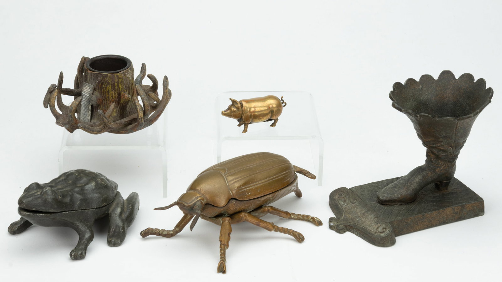 ASSORTED FIGURAL METAL MATCH HOLDERS, LOT OF FIVE: ASSORTED FIGURAL METAL MATCH HOLDERS, LOT OF FIVE, comprising three cast-iron examples, including a frog with hinged mouth and striker plate to the upper roof of mouth, a boot on platform with wide-ri