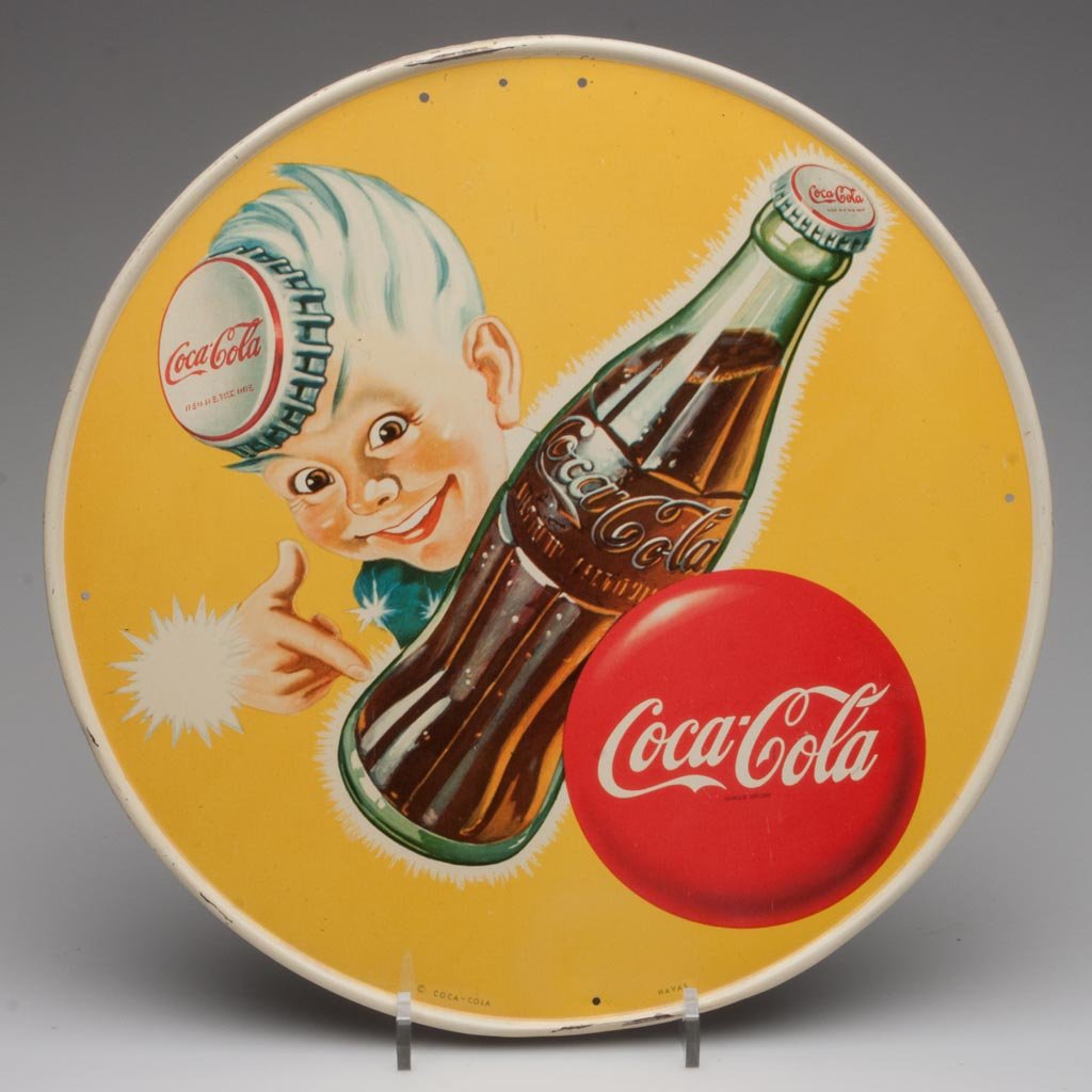 COCA-COLA SPRITE BOY TIN SIGN: COCA-COLA SPRITE BOY TIN SIGN, circular with embossed edge and mounting/hanging holes. Produced for export. Circa 1947. 12 3/4" D. Provenance: From a Connecticut private collection.