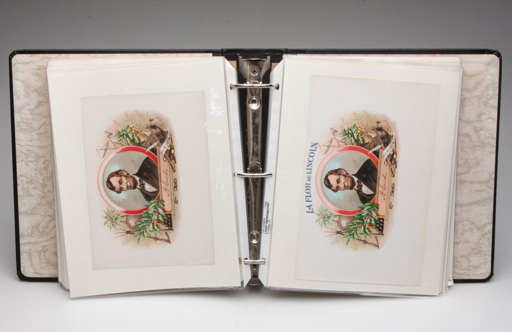 ASSORTED CIGAR BOX LABELS, ALBUM FULL: ASSORTED CIGAR BOX LABELS, ALBUM FULL, approximately 98, primarily full-color lithographed lid labels, very few duplicates, including Abraham Lincoln and other American historical. 20th century. Prove