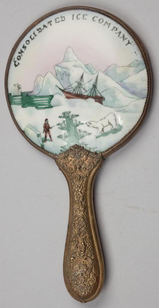 CONSOLIDATED ICE CO. ADVERTISING HAND MIRROR: CONSOLIDATED ICE CO. ADVERTISING HAND MIRROR, hand-painted porcelain depicting an arctic scene with icebergs, ship and polar bear, contained in a brass frame with bevel-edge mirror on back. Fourth qua